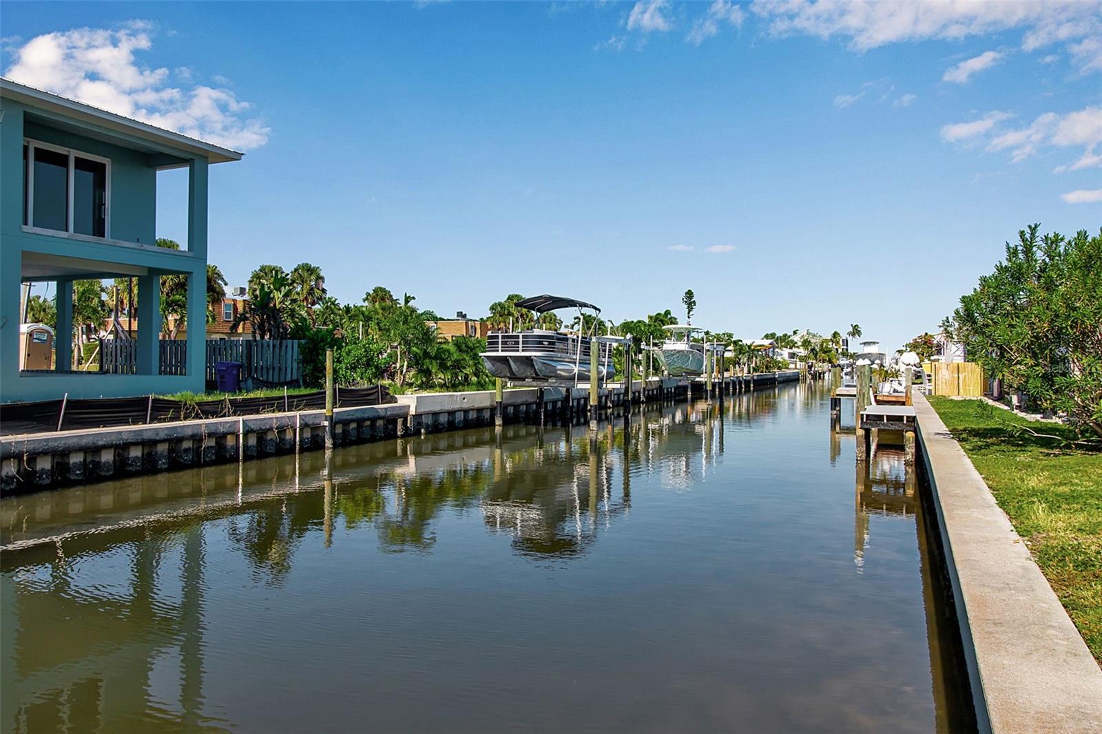Wake up to tranquil canal views, step outside to the water, and embrace the effortless island lifestyle that makes Longboat Key one of Florida's most sought-after coastal destinations.

This beautifully updated 2-bedroom, 2-bath waterfront condo offers 1,215 square feet of thoughtfully designed living space, along with a carport and two dedicated parking spaces—a rare convenience for island living. Perfectly positioned on a peaceful canal with direct access to the Intracoastal Waterway, this property is ideal for boating enthusiasts, investors, or anyone seeking a true waterfront retreat.

A brand-new private dock provides the perfect place to keep your boat, enjoy morning coffee by the water, or spend evenings watching the sunset over the canal.

Inside, the residence has been completely transformed into a clean, coastal-inspired retreat with high-end updates throughout. The fully permitted renovation was completed with an emphasis on quality craftsmanship, long-term value, and peace of mind.

The stunning new kitchen features updated cabinetry, countertops, and appliances, while both bathrooms have been thoughtfully redesigned with elegant, modern finishes that create a spa-like atmosphere. Beautifully updated vanities, new fixtures, designer tilework, and carefully selected finishes elevate the spaces, providing a luxurious and relaxing experience.

Additional improvements include a new A/C system, complete plumbing repipe with new water and sanitary lines, new water heater, upgraded electrical panel, and all new impact windows and exterior doors. The building also benefits from a durable metal roof installed in 2016, offering insurance advantages and low-maintenance ownership.

Beyond the exceptional lifestyle, the property also presents outstanding income potential, generating approximately $5,000+ per month during season and $3,500+ per month in the off-season, making it an ideal blend of personal enjoyment and investment performance.

Located just minutes from pristine Gulf beaches, local dining, shopping, and everyday conveniences, the property is also near Joan M. Durante Community Park, known for its scenic walking trails, native gardens, and breathtaking bayfront sunset views.

Rare Opportunity: The adjacent unit is also available, presenting the unique chance to own the entire building as a waterfront duplex—ideal for a private family compound, multi-generational living, or maximizing rental income potential.

Whether you're seeking a primary residence, seasonal escape, or income-producing investment, this property offers a rare combination of location, condition, boating access, and exceptional waterfront living.

Schedule your private showing today and experience the very best of Longboat Key living.