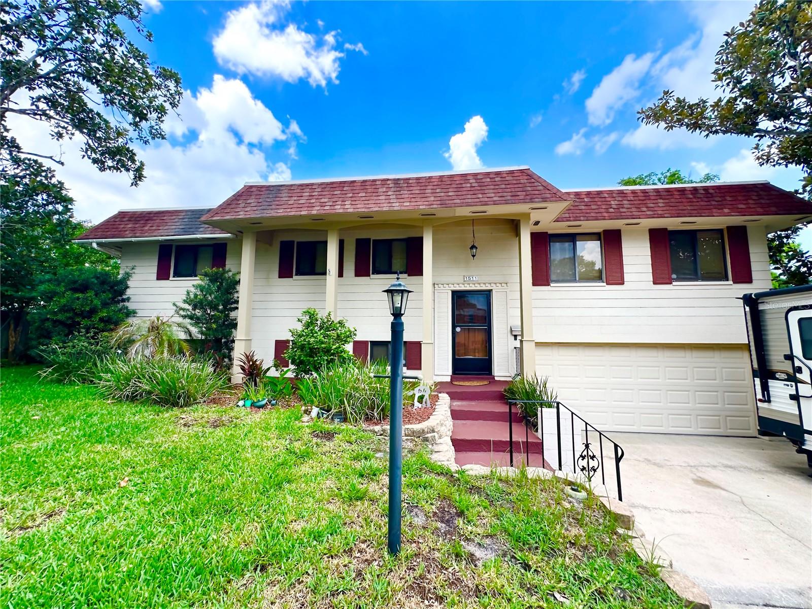 This AMAZING!, spacious 5-bedroom, 3-bath split-level home is located in a fantastic neighborhood and is packed with standout features. Upstairs, you’ll find beautiful engineered hardwood flooring throughout the main living areas, with carpet in the bedrooms and tile in the baths. A stunning screened-in porch overlooks the backyard and pool, offering a perfect spot to relax or entertain.

The bright and airy formal living room provides plenty of space, while the  dining room includes sliding doors that lead out to the porch. The large eat-in kitchen offers ample cabinet storage and even features a convenient pass-through window to the porch/outside bar—ideal for hosting.

The upper level includes three bedrooms two bathrooms.   Just a few steps down, the lower level opens to a massive family room with tile floors  set to entertain family and friends with two additional bedrooms with carpet and a full bath. Tile flooring runs throughout this level.

Additional highlights include  outdoor spa , updated windows, a re-piped plumbing system, updated Electrical, and a well-maintained interior full of character. The home comes with paid in full solar panels and a Terminix termite bond and Well Maintained  sprinkler system on well.  Washer/Dryer are located in the garage.  The garage include cabinets for additional storage.  The yard features mature Citrus trees and Magnolia trees adding to the home’s charm.

With its flexible layout, inviting screened porch, and beautiful salt water pool area, this home truly has it all.