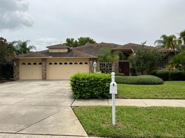 ** PRICE DRASTICALLY REDUCED FOR QUICK SALE** Country Club living at its best! This 3/2/3 car garage home with a beautiful brick accent elevation is situated on a corner lot in sought after Heritage Springs, a 55+ community in Trinity awaits you. Heritage Springs is a 24 hour guard gated, community offering a beautiful clubhouse, heated pool & spa, 18 hole championship golf course, pro shop, restaurant, tennis courts, fitness center, planned activities, etc. When you aren’t enjoying all of amenities this community has to offer, you can relax at home in your beautiful Florida room. The large, enclosed, Florida room boasts full-length windows overlooking the expansive grassy yard, lovely ceramic tile flooring, and sliders and windows that bring natural light and an openness to the family room, living room and kitchen. The kitchen overlooks the family room and offers plenty of oak cabinets, Corian countertops, a pantry, and you can have a quick breakfast at the island bar or enjoy a meal at the table in the breakfast nook. The foyer, formal dining room, and living room add an elegant feel to the home with soaring ceilings and plant ledges. The master bedroom features his & her closets and a fabulous en-suite bathroom offering double sinks, Corian countertops, a garden tub, and a large, walk-in, shower. The bedrooms feature beautiful wood laminate floors and the rest of the home has easy maintenance ceramic tile, No carpet!  A/C is 2019, water softener 2019, roof 2012, water heater 7/2023. Home is being sold as is for sellers convenience.  All room sizes are approximate and should be verified by buyers. Leasing and pet policies to be verified by buyers. Furniture is negotiable