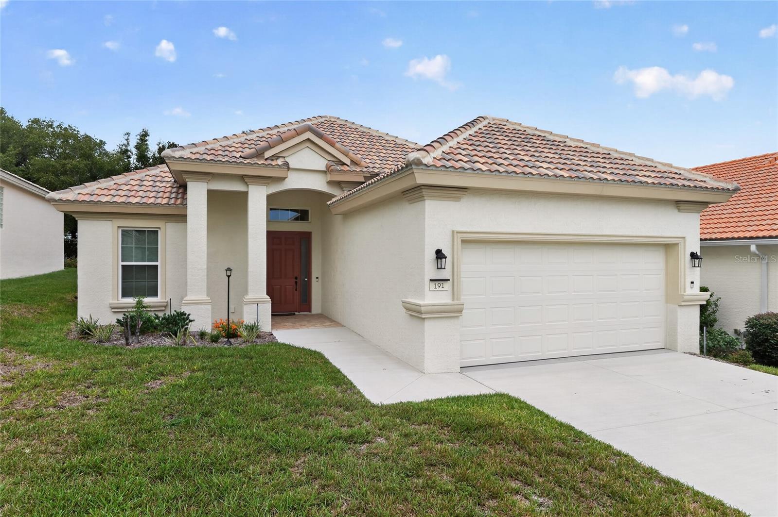 Looking for a truly turn-key home in an amenity-rich, gated community? This gorgeous 2025 home is elegant and spacious! A highly desirable Great Room design, 2 generously-sized bedrooms, the owner suite has TWO large walk-in closets (!), a perfect bonus room that could be a 3rd bedroom or office, 2-car garage, beautiful laundry room, a pocket door on the guest side of the split floor plan closes off that side of the home for added privacy! Main bathroom has a luxurious bath with a walk-in shower and dual sinks! The Great Room and Kitchen (with induction cooktop!) are open and perfect for entertaining, with the gorgeous screen-in paver lanai just off the great room that faces the lushly landscaped, quiet backyard! There's underground utilities, with the tiled solar roof the electric bill is only $45/month due to an additional layer on insulation under the tile on the roof. The home has been upgraded with HVAC UV lights the keep the air clean. This neighborhood is true resort living: take advantage of these amenities! Dine in 3 on-site restaurants, play in three 18-hole championship golf courses, make friends at the dog park, dance and listen to live music at the tiki bar, there's pickleball courts, three heated pools, a spa, a state-of-the-art fitness center, and live entertainment nightly! HOA fee includes internet, cable, lawn maintenance and exterior painting of the home every 5 years or so.  This area is known for outdoor living: bicycling, walking, boating, and fishing — along with shopping and all of life's necessities including medical, shopping and entertainment, all close by. This is more than a home; it's a lifestyle!
