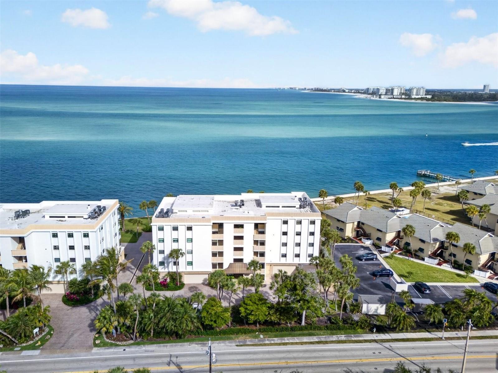 Expansive floor-to-ceiling sliders open wide to welcome refreshing Gulf breezes and showcase unobstructed, panoramic water views, turning your open-floorplan living space into an indoor/outdoor oasis. With over 2,300 square feet, this light-filled condominium lives like a private home suspended above shimmering waters. The gourmet kitchen is both elegant and functional, featuring quartz countertops, custom wood cabinetry, and premium appliances, including a Thermador refrigerator and freezer, Wolf double ovens, Wolf microwave, and a Thermador induction cooktop. Panel-ready finishes, a built-in beverage cooler, and exceptional storage make this space ideal for both everyday living and entertaining. Rich acacia engineered wood flooring adds warmth and sophistication throughout the main living areas. The spacious primary suite captures sweeping Gulf views and offers a serene escape, complete with a beautifully renovated spa-inspired bath featuring split vanities and a large walk-in shower. Two additional bedrooms and stylishly updated baths are thoughtfully positioned on the opposite side of the residence for added privacy. Impact-rated windows and sliders provide peace of mind, eliminating the need for hurricane shutters. A private two-car garage with ample storage adds to the home’s convenience. Windward Passage features a Gulf-side pool, lushly landscaped grounds, and a pet-friendly setting. Perfectly positioned on the sought-after north end of the key, you’re just a short walk to the Village for charming boutiques, dining, and live entertainment.