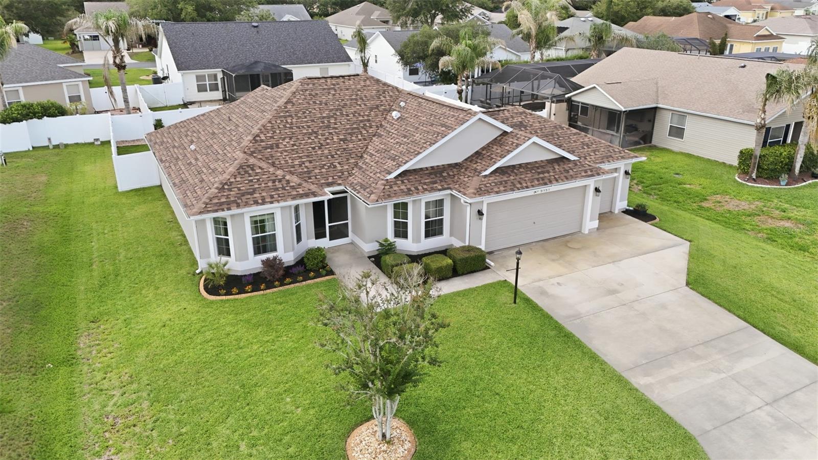 Welcome to refined Florida living in the highly sought-after Bison Valley community — a premier golf cart-friendly neighborhood developed by The Villages with no age restrictions and direct golf cart access to shopping, dining, entertainment, and more. This impeccably upgraded 3-bedroom, 2-bath residence seamlessly blends modern luxury, thoughtful design, and exceptional indoor-outdoor living.

From the moment you arrive, the enhanced landscaping, screened front porch, and inviting entry create a striking first impression. Inside, every detail has been thoughtfully curated, featuring soaring vaulted ceilings accented with custom wood beams, freshly painted interiors, luxury vinyl plank flooring throughout the bedrooms, and designer lighting and ceiling fans throughout the home. The vaulted primary suite creates a spacious private retreat, while all three generously sized bedrooms are large enough to comfortably accommodate king-size bedroom sets.

The heart of the home is the beautifully remodeled kitchen, showcasing professionally painted cabinetry, stunning quartz countertops throughout, Samsung stainless steel appliances, a custom herringbone tile backsplash, updated sinks and fixtures, and elegant custom cornice boards. Triple sliding glass doors seamlessly connect the expansive living area to the screened lanai and oversized concrete patio, creating the ideal setting for entertaining or relaxing in your fully fenced backyard oasis — perfect for both outdoor living and your fur babies to roam safely.

Major system upgrades provide exceptional peace of mind, including a new roof installed in 2024 that is still under warranty, a new HVAC system and water heater installed in 2022, updated irrigation components, professional termite protection, ongoing lawn treatment maintenance, and a recent HVAC tune-up.

Car enthusiasts and golf cart owners will appreciate the extra-deep 2-car plus golf cart garage complete with a new garage door opener. Additional highlights include a whole-property irrigation system fed by a well, a rescreened lanai, and continued landscape enhancements completed in 2026. A Yamaha battery-powered golf cart is also available separately outside of the real estate transaction.

Ideally positioned with The Villages located just across the street from the neighborhood, this exceptional property offers convenient access to The Villages Charter School, medical offices, premier shopping, restaurants, entertainment, and everyday conveniences — including the new Costco located less than half a mile away. Combining luxury upgrades, an unbeatable location, and lifestyle-focused living, this home presents a rare opportunity in one of Central Florida’s fastest-growing communities.

This remarkable home won’t last long—schedule your private showing today!