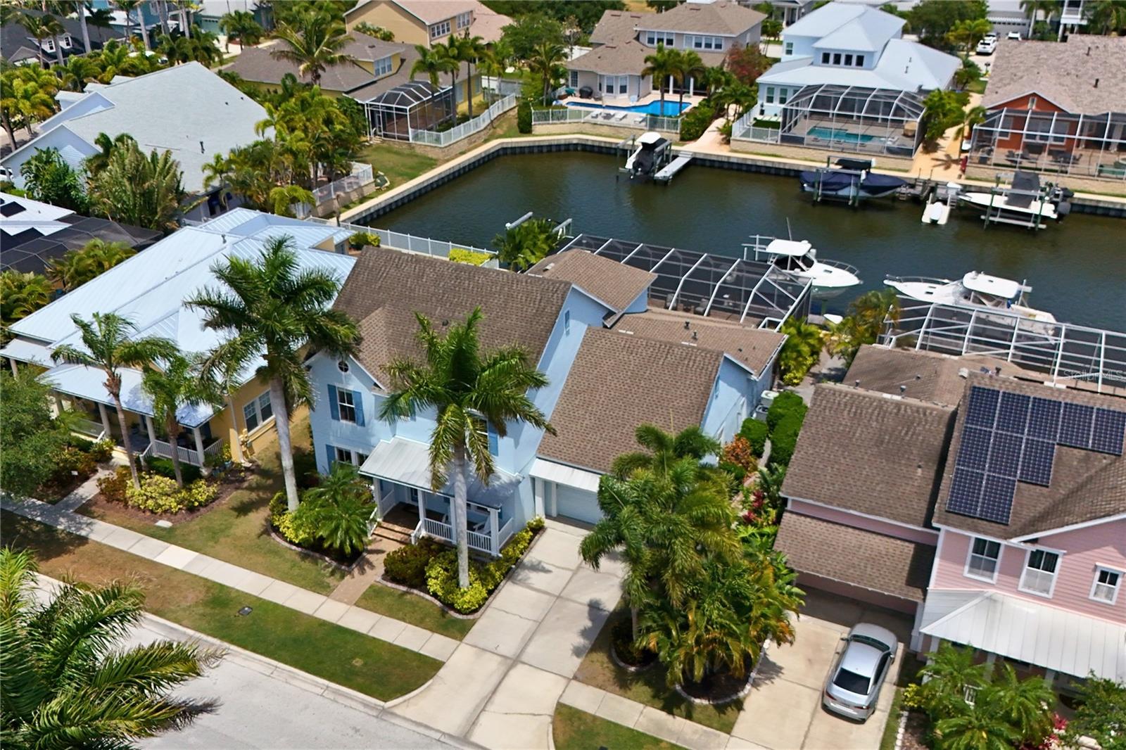 Best value in town with direct access to Tampa Bay. David Weekley builder, “Sand Dollar” model offers the ideal setting for families who love entertaining, boating, and making memories together. Expansive layout, and thoughtfully designed indoor-outdoor spaces create an inviting atmosphere that feels both elegant and comfortable. Inside, the spacious floor plan offers flexibility for growing families with a large private office featuring French doors, perfect for working from home, a playroom, or study space.
At the center of the home is an oversized gourmet kitchen designed for gathering and connection. Featuring upgraded Silestone countertops, upgraded 42-inch cherry cabinetry with glass inserts, stainless steel appliances including a new refrigerator, dishwasher, and microwave, double ovens, gas cooking, a large center island, and an expansive breakfast bar, this kitchen provides exceptional storage, prep space, and seating for everyday family living and entertaining alike. The adjoining family room creates a warm and welcoming space with a custom built-in entertainment center, electric fireplace, and accent lighting that makes evenings at home feel cozy and inviting.
Upstairs, a dedicated theater/media room offers the perfect place for movie nights, gaming, or relaxing together after a day on the water. The oversized primary suite serves as a peaceful retreat, a spacious walk-in closet, dual vanities, and a luxurious bath featuring a Jacuzzi jetted tub. Additional storage beneath the staircase and throughout the home adds both convenience and functionality for busy family life.

Outdoor living is where this home truly shines. The expansive screened paver lanai is designed for year-round enjoyment and entertaining, complete with a recently resurfaced pool, built-in LED lighting, generous covered seating areas, and a fully equipped outdoor kitchen with grill and prep space. The pet-friendly turf area creates a safe and low-maintenance space for children and pets to play while enjoying the beautiful waterfront setting.

For boating enthusiasts, the private dock and 16,000 lb boat lift provide quick and convenient access to Tampa Bay, making sunset cruises, fishing trips, and weekends on the water part of everyday life.
Located within the resort-style community of MiraBay, residents enjoy access to outstanding amenities including a clubhouse with fitness center, heated pool with slide, pool side cafe, 4 clay tennis courts, 4 new pickleball courts, 2 basketball courts, playgrounds, parks, walking trails, community events, and a stunning 136-acre lagoon ideal for kayaking, paddle boarding, canoeing, and sailing.
This exceptional waterfront home offers the perfect balance of luxury, recreation, family-friendly living, and the Florida lifestyle so many dream about. Schedule your private showing today.