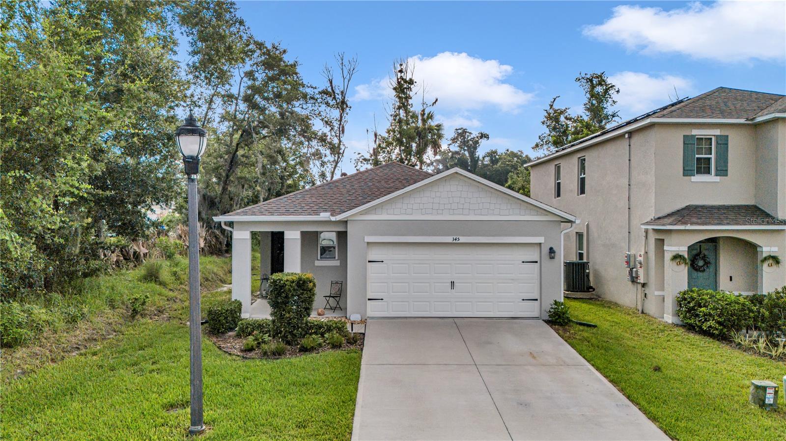Welcome to this stunning D.R. Horton "Jemison" home, perfectly situated on a corner lot in the highly sought-after Pelham Park subdivision. Built in 2023 and beautifully maintained, this 3-bedroom, 2-bathroom residence offers an exceptional blend of modern comfort, smart technology, and thoughtful design. Step inside to a spacious, light-filled foyer featuring inset lighting that sets an inviting tone for the home's bright, open-concept layout. At the heart of the home is a chef-friendly kitchen boasting sleek stainless-steel appliances and laminate countertops. The private primary suite serves as a relaxing retreat, complete with a generous walk-in closet and an upgraded ensuite bathroom featuring a double vanity and a ceramic-tiled shower. Two additional bedrooms share a bright second bath equipped with a convenient shower-tub combination. Natural light pours into the main living space through sliding glass doors that open to a private, peaceful lanai with a wooded buffer between neighbors, offering the ultimate setting for outdoor relaxation. 

This turnkey home is packed with premium, practical upgrades, including new gutters installed in 2025, a transferable Massey termite bond, a three-zone sprinkler system with automated timers, and seamless carpet and tile flooring throughout. Everyday convenience is built-in with a dedicated utility room that includes the washer and dryer, a two-car garage with an automatic opener, and enhanced safety from six integrated fire and carbon monoxide detectors. Connected to city water and sewer (with estimated monthly costs available upon request). The Community also has perks like a neighborhood playground, gazebos, and walking trails, making it an excellent primary residence or a high-potential rental opportunity. Location is unmatched for commuters, offering an easy drive to Orlando, Daytona Beach, and nearby Stetson University, while sitting approximately one mile from the DeLand SunRail Station. Don't miss your chance to own this move-in-ready gem with strong value in booming DeLand—schedule your private tour today, available by appointment only.
