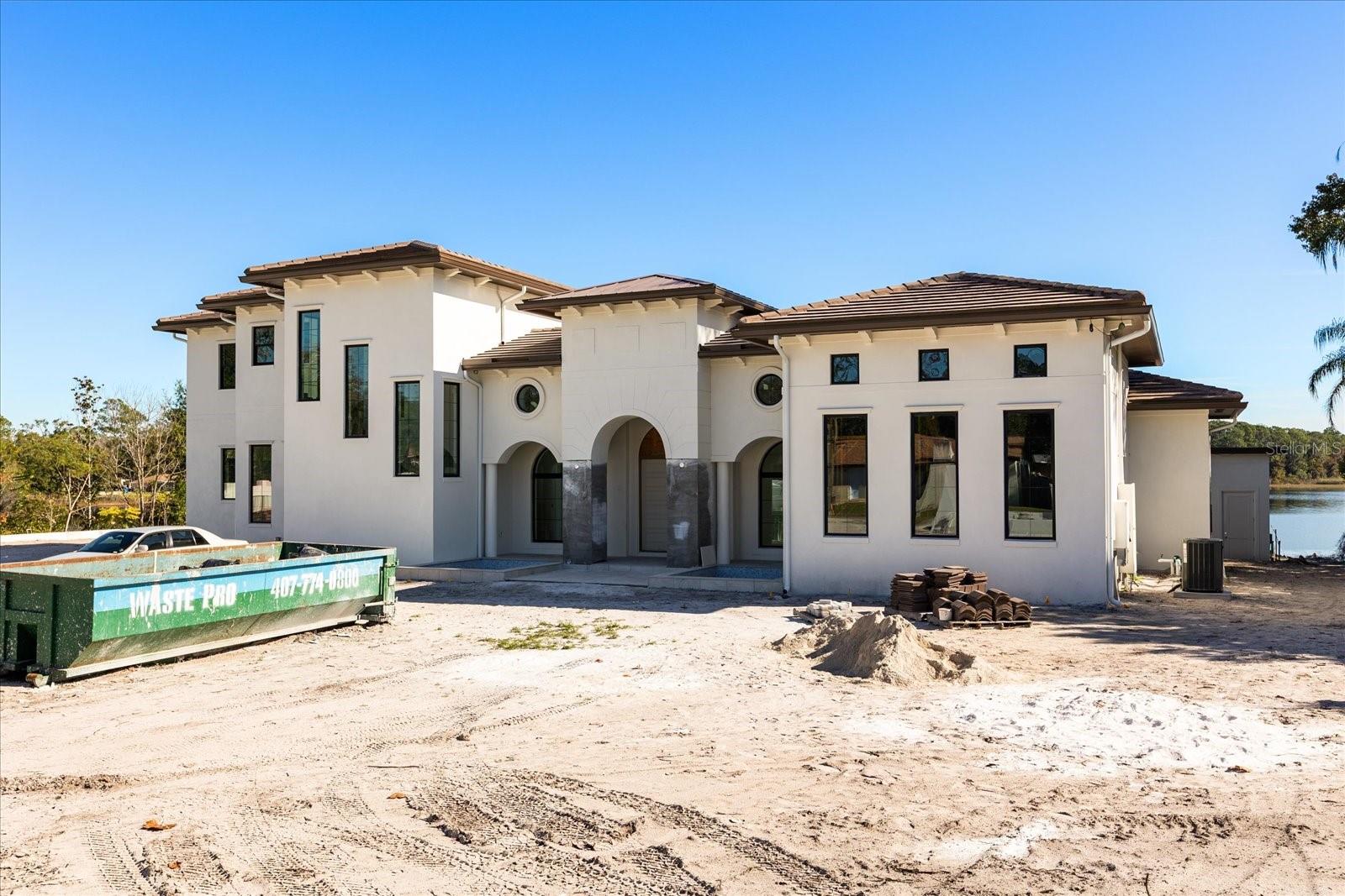 Under Construction. SELLING - UNFINISHED - AS IS. 85% complete and ready for the buyer to make their final selections! An extraordinary lakefront opportunity on Little Lake Mary, one of Lake Mary’s most coveted private waterfront enclaves. This lakefront custom-built luxury estate sits on over an acre offering a rare opportunity for a buyer to step in and finish the final design selections to their own vision.

This is not a rendering. Construction is well underway and the home is already substantially built. The seller has decided not to select the final finishes, creating a unique opportunity for a buyer to purchase the home as-is and personalize the final elements without starting from scratch.

Designed as the seller’s forever dream home, the residence was thoughtfully planned with intention, scale, and timeless lakefront living in mind. The estate spans approximately 7,000 square feet with up to five bedrooms and four bathrooms, including two primary suites, one on each level, ideal for multigenerational living or elevated guest accommodations, with elevator access between floors.

The downstairs primary suite is designed as a private retreat with fireplace, luxury sauna, spa-style bathroom, and direct access to outdoor living areas. Upstairs, the second primary suite captures sweeping lake views and opens to a private balcony overlooking the water.

Main living spaces feature soaring ceilings, expansive lake-facing windows, and a large chef’s kitchen anchoring the open-concept great room and entertaining areas. A dedicated golf simulation room offers flexibility as a golf studio, media room, private lounge, gy,, next gen living space or recreation space.

Planned outdoor living includes a resort-style pool and spa with water features overlooking the lake, expansive covered entertaining areas with outdoor kitchen and bar seating, multiple gathering zones, and a fire pit lounge. The property also features a private boat ramp and expansive shoreline along Little Lake Mary.

A gated entrance leads to a large driveway designed for gatherings and multiple vehicles. A detached flex building offers additional space ideal for a gym, studio, office, or creative retreat while maintaining privacy from the main residence.

With the structure nearing completion, buyers can finalize key selections including flooring, countertops, lighting, and landscaping allowing personalization of a luxury lakefront estate without the extended timeline of building from the ground up.

Located in the highly desirable 32746 zip code near top-rated schools, downtown Lake Mary dining, parks, and convenient access to I-4 and 417. Little Lake Mary is treasured for its calm waters, stunning sunsets, and rare balance of privacy and central location.

Lakefront parcels of this caliber almost never become available especially with a nearly completed luxury home already in place. This is a rare chance to complete and personalize a legacy lakefront estate on Little Lake Mary. Reach out to us for an incredible video and to schedule your private showing today!