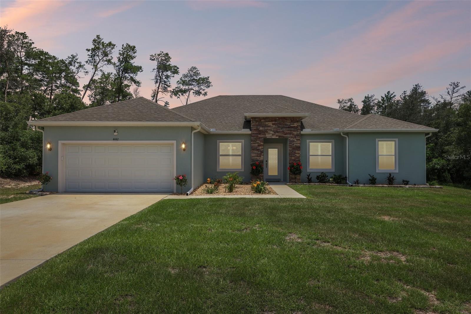 Built in 2022 and situated on over half an acre with no HOA, this impressive 4-bedroom, 3-bathroom home offers 2,367 square feet of thoughtfully designed living space and a peaceful, private setting surrounded by mature trees. A spacious 2-car garage and expansive backyard provide endless possibilities for enjoying the Florida lifestyle. Inside, the open-concept layout seamlessly connects the kitchen, living room, and dining area, creating an inviting space for everyday living and entertaining. A formal dining room and versatile flex space at the front of the home offer additional room for a home office, playroom, or hobby area. The kitchen is designed to impress with a large center island, abundant cabinet and counter space, and a breakfast nook overlooking the spacious living room. A two-panel sliding glass door fills the home with natural light and provides access to the covered patio. The primary suite features a tray ceiling and an en suite bath with a dual-sink vanity and oversized walk-in shower. Three additional bedrooms provide flexibility, while one of the secondary bathrooms offers convenient access to the backyard patio. Vinyl flooring extends throughout the main living areas, with carpet in the bedrooms for added comfort. Conveniently located near healthcare facilities, grocery stores, nature preserves, Paddock Mall, and with easy access to I-75, this exceptional Ocala property combines modern living with privacy and convenience. Mortgage savings may be available for buyers of this listing.