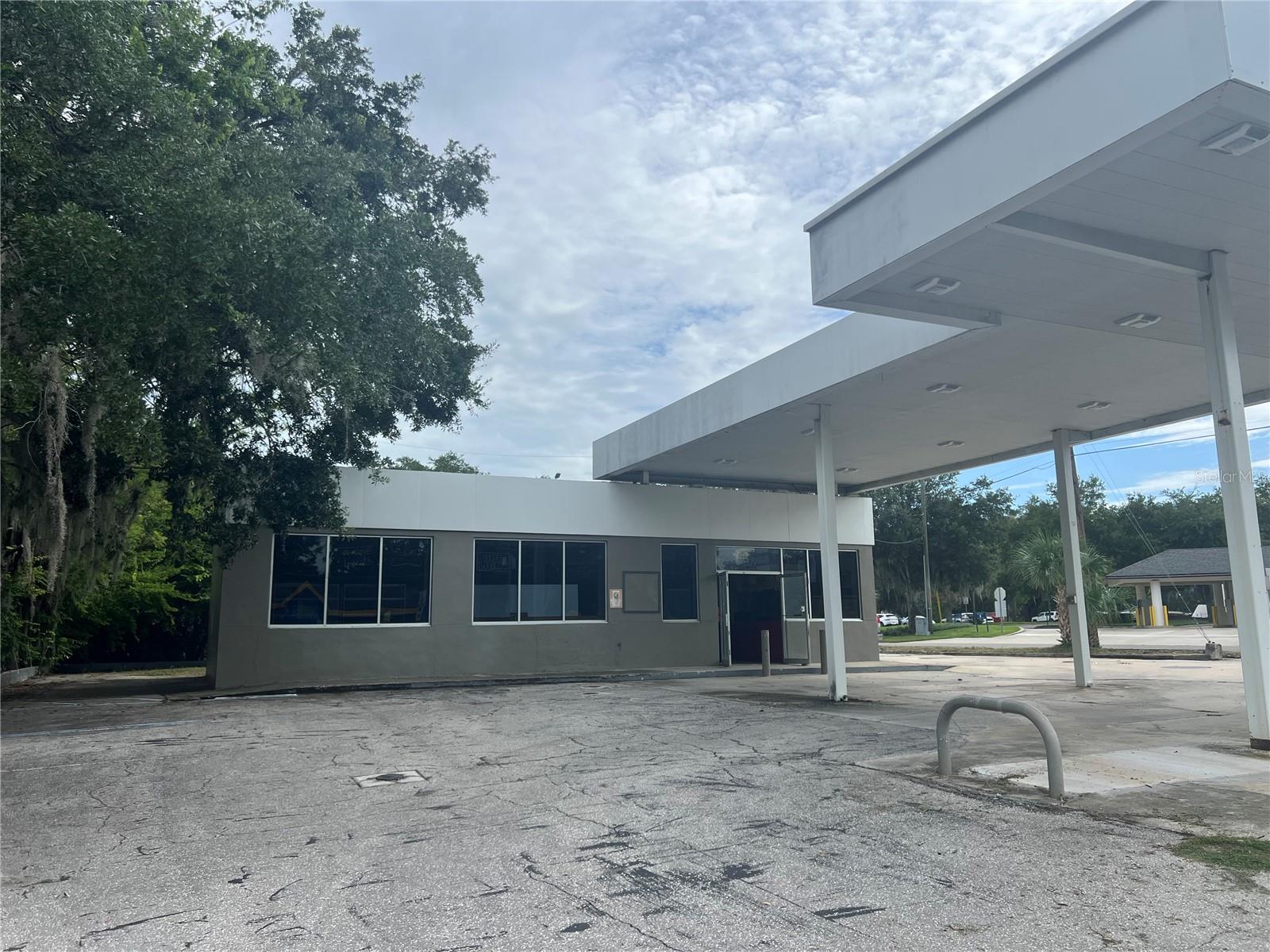 Once a bustling gas station, this site now presents a rare investment opportunity in a high visibility, high-traffic area. Only one mile from historic downtown Ocala! Situated on a generous corner lot directly on Silver Springs Blvd this is a prime location with steady vehicle and foot traffic. This property includes a 1555 sq ft building with open-interior space, large display windows, and a covered 1525 sq ft pump canopy prefect for creative reuse. With city utilities already in pace and flexible zoning (verify with local municipality), it's ideal for investors or entrepreneurs looking to transform the space into a profitable venture. Zoned for commercial use, its perfect for a unique retail shop, café, brewery, restaurant, salon, etc. Whether you're looking to restore, repurpose, or redevelop, this property offers a solid foundation.
This site currently has a closed in place underground fuel tank approved by the state. The tank is filled with grout therefore not useable. The environmental condition has a minimal impact on redevelopment. Seller will provide latest reports and help buyer with appropriate state agency contacts for further information. Sold as is- ready for your vision.