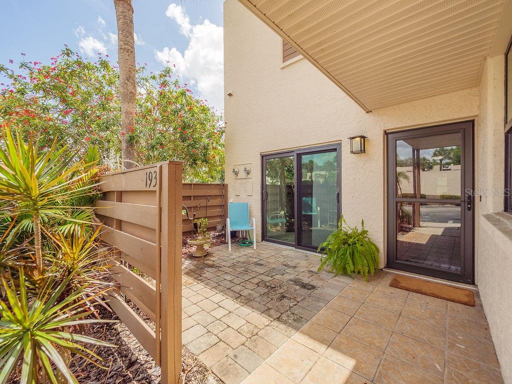 Step into a world where nature meets modern luxury in this rarely available corner-unit sanctuary. Nestled within the lush, 88-acre Audubon bird and wildlife sanctuary of Wildewood Springs, this first-floor residence offers the ultimate in privacy and convenience—with no stairs to climb and no rear neighbors to interrupt your view. As you drive through the tropical, canopy-lined streets, you’ll feel the pace of the world slow down before you even reach your front door.

The experience begins at your private, oversized front patio, an expansive outdoor retreat perfect for slow morning coffees or hosting sunset cocktails. Inside, a top-to-bottom contemporary remodel has transformed this space into a designer showpiece. Wide-plank luxury vinyl flooring flows seamlessly under recessed lighting, while the brand-new kitchen serves as the heart of the home, featuring premium quartz countertops, sleek stainless appliances, and dual pantries for the ultimate culinary organization.

The primary suite is a true escape, boasting dual closets and a spa-inspired ensuite featuring marble countertops and high-end designer finishes. Guests will feel equally pampered in the second bedroom, which also includes a spacious walk-in closet and luxurious ensuite bathroom with walk in shower. 

Functionality is just as prioritized as aesthetics here. You’ll find an abundance of storage throughout, including a dedicated laundry closet and a massive storage room off the Florida room. This oversized space is a "handyman’s dream," offering enough room for a workshop or "garage-style" storage for all your coastal gear. A newer roof replaced in 2023 and impact resistant glass offer both peace of mind and unobstructed views of the vibrant bird sanctuary just steps away.

Beyond your front door, Wildewood Springs offers a vacation lifestyle with heated pools, spas, tennis, and pickleball courts. You’re perfectly positioned just a short drive from the sugar-sand beaches of Anna Maria Island, gourmet dining, and the Sarasota International Airport. This isn't just a condo; it’s a masterfully renovated retreat designed for those who refuse to compromise on style, serenity, or convenience.