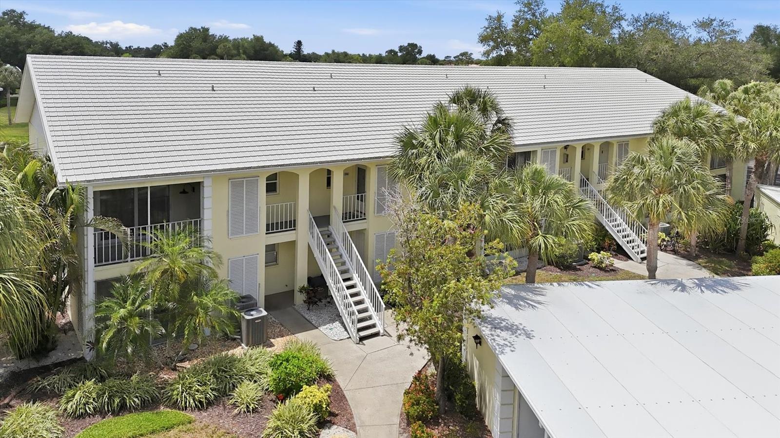 Opportunity is knocking! 2nd floor, furnished condo with a southeast view across the pond in Farmington Vistas at The Plantation.  Cathedral ceilings enhance the spacious feel. Cook friendly kitchen opens to the dining space across a breakfast bar and includes a closet pantry.  Primary bedroom features include a private balcony, a walk-in closet, and an en-suite bath.  2nd bedroom opens to the screened lanai. Bring your decorating ideas to make this property your own.  NO CDD FEES.
Membership in the private golf & country club is optional.