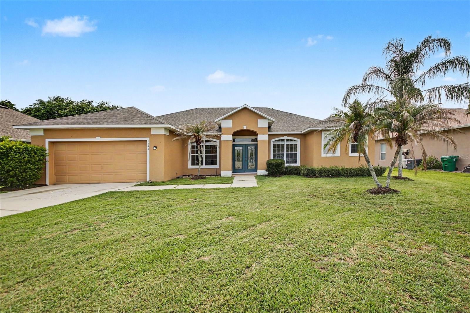 This 4-bedroom, 2-bathroom single-story home offers a versatile and comfortable layout featuring a blend of carpet, wood, and ceramic flooring throughout. The interior is designed for spacious living, highlighted by oversized secondary bedrooms equipped with full-length mirrors that add both depth and functionality. The living spaces flow seamlessly to the outdoors, where a screen-enclosed back patio provides a private, pest-free retreat for year-round relaxation. Complete with an attached two-car garage, this home perfectly balances practical amenities with a diverse mix of quality interior finishes.
