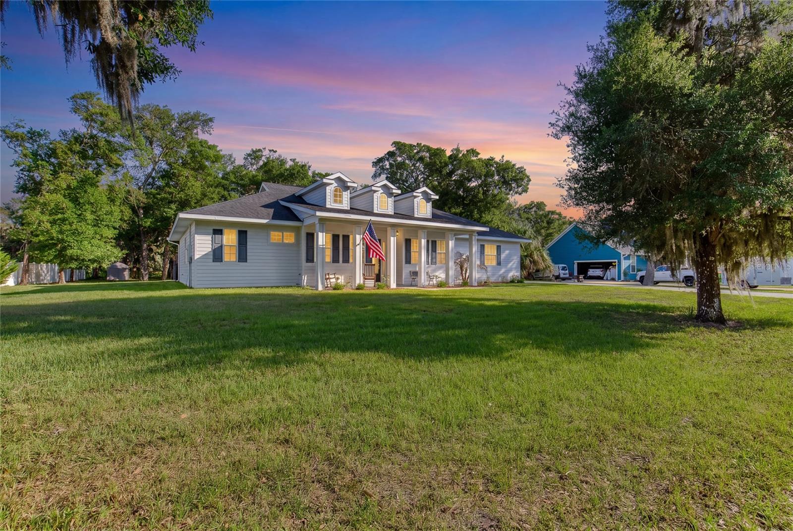 Welcome to this beautifully custom-designed home, featuring 4 bedrooms, 3 full bathrooms, and a spacious 2-car garage, located in the highly sought-after Oakview Acres neighborhood of Flagler Beach. Nestled on a tranquil cul-de-sac off John Anderson Highway, this property spans nearly an acre of lush land, providing a serene retreat just minutes away from shopping, restaurants, parks, fishing spots, and I-95. Built by Budgen Construction in 2019, this residence has hurricane impact windows and doors, elegant yet durable 30'' x 6'' porcelain tiles throughout, and GE stainless steel appliances. The solid quartz countertops, soaring 10' ceilings with decorative tray details, and 8' interior doors enhance the home's inviting atmosphere. A charming 30' x 6' front porch welcomes you, exuding an old-world southern charm. As you enter, a spacious foyer leads to the formal dining room and the expansive great room and kitchen beyond. The kitchen, truly the heart of the home, features a walk-in

pantry, 42" upper cabinets with soft-close doors and drawers, solid quartz countertops, and a stainless steel GE appliance package including dishwasher, side by side refrigerator/freezer, glass top range with convection oven and microwave. The eat-at center island, topped with accent mica-flaked quartz, is perfect for casual dining and gatherings in addition to the 10' x 11' breakfast nook.
The primary suite is a personal sanctuary, offering serene views to both the east and south. The oversized ensuite bathroom is designed for relaxation, complete with a walk-in shower, his and her vanities, a corner soaking tub, and a walk-in closet equipped with custom organizers. The three additional bedrooms are equally inviting, each featuring decorative tray ceilings, ceiling fans, and ensuite bathrooms for added convenience.
Step outside to the 18' x 8' covered rear patio, which overlooks a private in-ground saltwater pool surrounded by Tuscany travertine decking. The 28' x 14' pool features an 11' sunshelf, a swimout and LED bubbler lights, creating a perfect ambiance for outdoor relaxation. An aluminum fence provides safety while maintaining unobstructed views of the mature trees and neighboring pasture lands, enhancing the natural beauty of this remarkable offering.
Additional features include a whole house water filtration & softening system, security system, extra large septic tank and drain field, fencing along both side and rear property lines, an extra wide driveway and an outdoor storage shed in which to house lawn and garden equipment. The interior laundry room which comfortably fits a full sized washer and dryer also has a sink and cabinets for additional storage. (Washer & Dryer do not convey.)