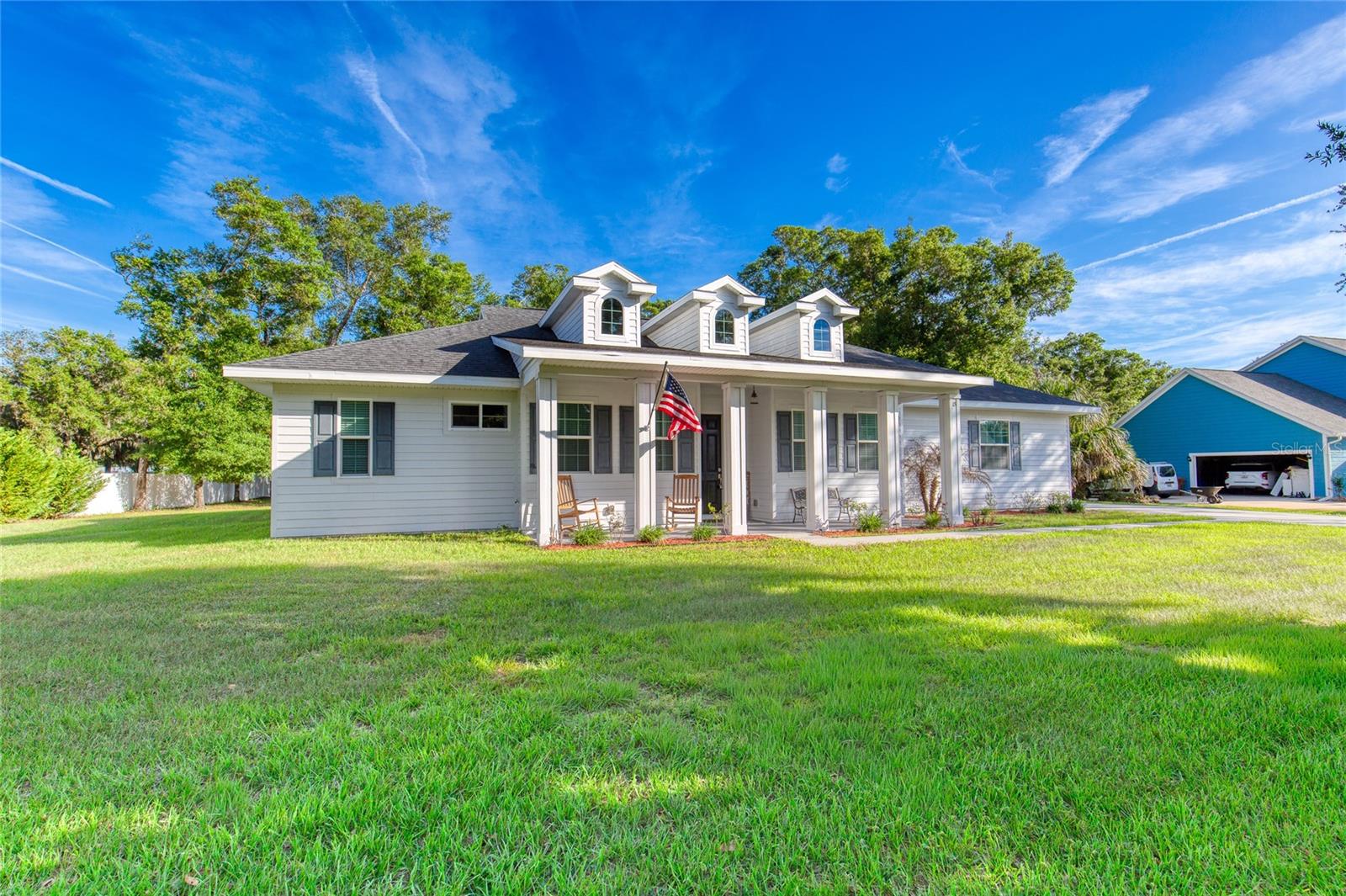 Welcome to this beautifully custom-designed home, featuring 4 bedrooms, 3 full bathrooms, and a spacious 2-car garage, located in the highly sought-after Oakview Acres neighborhood of Flagler Beach. Nestled on a tranquil cul-de-sac off John Anderson Highway, this property spans nearly an acre of lush land, providing a serene retreat just minutes away from shopping, restaurants, parks, fishing spots, and I-95. Built by Budgen Construction in 2019, this residence has hurricane impact windows and doors, elegant yet durable 30'' x 6'' porcelain tiles throughout, and GE stainless steel appliances. The solid quartz countertops, soaring 10' ceilings with decorative tray details, and 8' interior doors enhance the home's inviting atmosphere. A charming 30' x 6' front porch welcomes you, exuding an old-world southern charm. As you enter, a spacious foyer leads to the formal dining room and the expansive great room and kitchen beyond. The kitchen, truly the heart of the home, features a walk-in

pantry, 42" upper cabinets with soft-close doors and drawers, solid quartz countertops, and a stainless steel GE appliance package including dishwasher, side by side refrigerator/freezer, glass top range with convection oven and microwave. The eat-at center island, topped with accent mica-flaked quartz, is perfect for casual dining and gatherings in addition to the 10' x 11' breakfast nook.
The primary suite is a personal sanctuary, offering serene views to both the east and south. The oversized ensuite bathroom is designed for relaxation, complete with a walk-in shower, his and her vanities, a corner soaking tub, and a walk-in closet equipped with custom organizers. The three additional bedrooms are equally inviting, each featuring decorative tray ceilings, ceiling fans, and ensuite bathrooms for added convenience.
Step outside to the 18' x 8' covered rear patio, which overlooks a private in-ground saltwater pool surrounded by Tuscany travertine decking. The 28' x 14' pool features an 11' sunshelf, a swimout and LED bubbler lights, creating a perfect ambiance for outdoor relaxation. An aluminum fence provides safety while maintaining unobstructed views of the mature trees and neighboring pasture lands, enhancing the natural beauty of this remarkable offering.
Additional features include a whole house water filtration & softening system, security system, extra large septic tank and drain field, fencing along both side and rear property lines, an extra wide driveway and an outdoor storage shed in which to house lawn and garden equipment. The interior laundry room which comfortably fits a full sized washer and dryer also has a sink and cabinets for additional storage. (Washer & Dryer do not convey.)