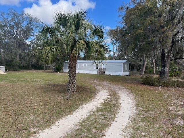 Short Sale. This is a fantastic first home on a corner wooded lot on over five acres close to the Suwannee River!  This completely renovated home two years ago is absolutely move in ready.  Beautiful vinyl plank floors throughout home for low maintenance living.  Kitchen is gorgeous with butcher block counter tops and stainless appliances.  Living space is very open to have your big sectional and TV for everything you like watch with friends and family. Main bedroom has walk in closet, big bathroom with granite counter tops and walk in shower.  Second bedroom is a great size with a bathroom just outside for family and guests.  The five plus acres have gorgeous big live oaks to enjoy and explore.  Lean to storge with dog run in back yard for pets and yard toys!  AC, hot water heater and septic are two years old! Great property!