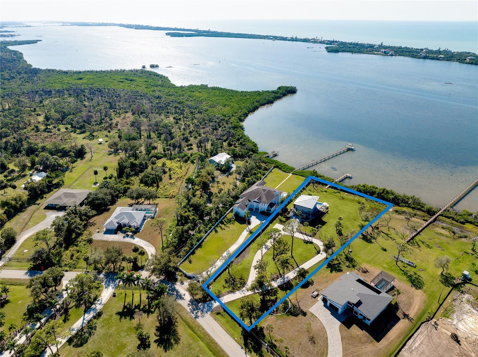 Waterfront Legacy Estate on 1.57 Acres with Dock, Bay Views & Income Potential
An extraordinary waterfront sanctuary spanning 1.57 acres with more than 200 feet of pristine Bay frontage, this exceptional estate commands breathtaking views across Lemon Bay and offers a rare blend of privacy, elegance, lifestyle and long-term opportunity.
Arrive through a gated entrance and sweeping circular drive to discover a secluded coastal retreat framed by mature, thoughtfully curated landscaping. Fully furnished and impeccably presented, the residence is designed for effortless waterfront living — whether hosting family gatherings, welcoming guests arriving by boat, or enjoying quiet mornings watching the water awaken from your private balcony.
Inside, soaring 23-foot floor-to-ceiling windows create a dramatic sense of scale while perfectly capturing the shimmering Bay beyond. The open-concept great room flows seamlessly into the gourmet kitchen and refined dining space, ideal for entertaining on any scale.
The chef’s kitchen is a showpiece, featuring brand-new premium appliances including double wall ovens, a warming drawer, wine cooler, French-style refrigerator, granite-adorned center island and bespoke finishes throughout.
Four beautifully appointed bedrooms and three luxurious bathrooms include a serene primary suite with its own private water-view balcony — a peaceful haven overlooking the Bay.
Outdoor living is equally compelling. Expansive decks spill toward the resort-style pool, newly upgraded equipment and sun-soaked entertaining zones creating a seamless indoor-outdoor experience. A brand-new metal roof provides both architectural finish and long-term peace of mind.
At the water’s edge, a newly constructed private dock offers direct Bay access — perfect for cruising Lemon Bay, kayaking at sunrise, or welcoming friends arriving by boat for sunset drinks beside the pool.
The lower level features walk-out access to the pool terrace along with a convenient laundry and pool bath, making entertaining and waterfront living completely effortless.
A Rare Opportunity for Future Growth & Income
Beyond its immediate lifestyle appeal, the expansive acreage presents outstanding potential for long-term wealth creation. The generous grounds invite consideration for a guest residence, subdivision or luxury retreat accommodation — opening the door to Airbnb income streams or multigenerational living in a premier waterfront setting (subject to local approvals).
Optional membership to the Englewood Gardens Beach Club further elevates the offering, granting access to a private beachfront clubhouse, gazebo with gas grills, Bayfront kayak launch, storage facilities and complimentary beach parking.
From sun-drenched afternoons by the pool to evening cruises across the Bay, every detail of this property has been designed to inspire tranquility, prosperity and lasting memories.
This is more than a home.
It is a waterfront legacy — a place where lifestyle, luxury and long-term vision converge.