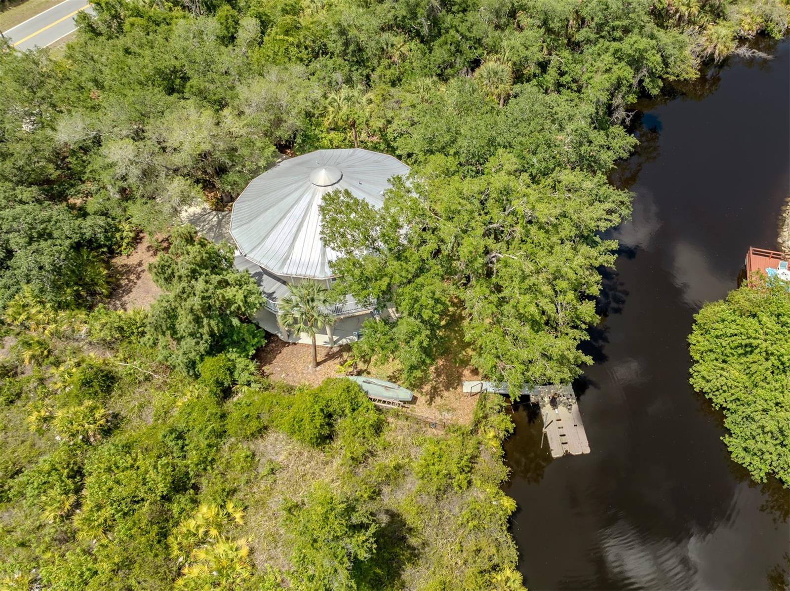 Tucked high among the trees and overlooking the Myakka River, this one-of-a-kind home offers a rare blend of privacy, charm and convenience. Custom built in 2004, this residence features two spacious bedrooms, two full baths, and an additional half bath thoughtfully designed for guests and entertaining. Whole-home generator added for peace of mind. Elevated to capture tranquil water views and surrounded by lush natural beauty, the home feels like a private retreat while remaining just minutes from shopping, dining, medical facilities, golf, parks, beautiful sandy beaches as well as everyday conveniences. Large windows and inviting outdoor spaces bring the beauty of the surroundings inside, creating a bright and relaxing atmosphere throughout. The open-concept living areas are designed with coastal living, abundant natural light and seamless flow between the kitchen, dining and living spaces. Each bedroom is spacious and convenient to all living spaces. Whether enjoying morning coffee among the treetops, watching wildlife along the river, or taking a short drive to nearby restaurants and services, this distinctive property delivers a balance of serenity and accessibility. Ideal as a full-time resident or seasonal getaway, this elevated waterfront home is a hidden gem ready for you to call it home. Schedule your private showing today. You will be glad you did!