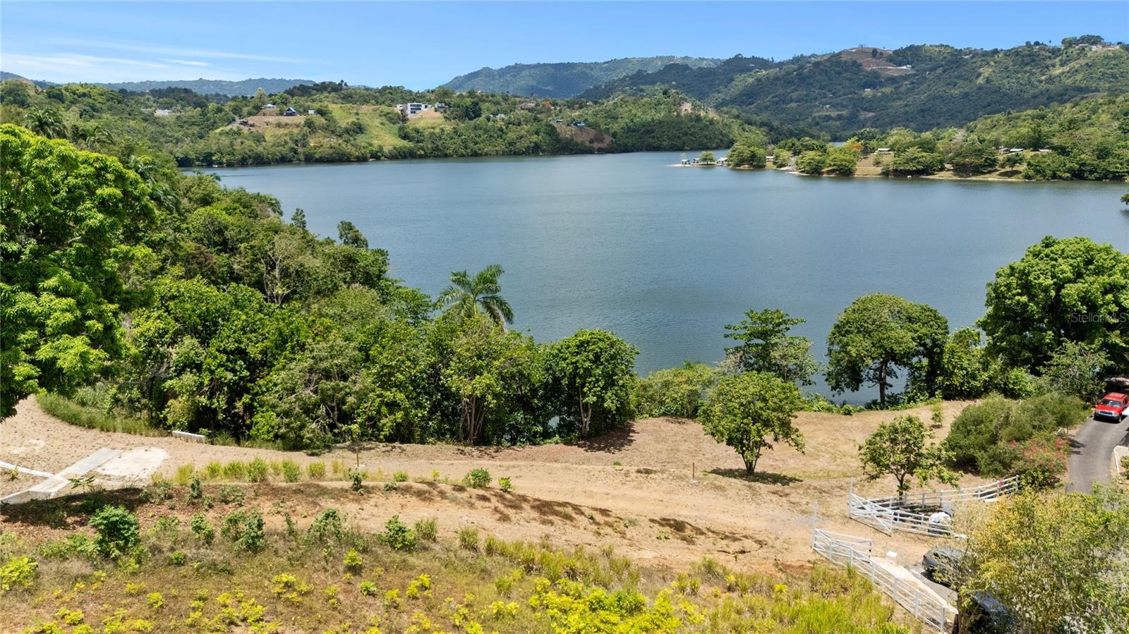 Located in Bo. Ortiz, Toa Alta, Puerto Rico, these two adjoining parcels, being sold together, present a total of 15.63 cuerdas of land with direct access to Lake La Plata, a rare and highly desirable feature in the area. One parcel consists of 7.56 cuerdas and the other 8.07 cuerdas, providing ample space and exceptional flexibility. The property's natural surroundings, open lake views, and lush vegetation create an ideal setting for a private residence, a family compound, or a custom development designed to embrace privacy, space, and a premium connection to nature. The combined size of the parcels allows for thoughtful planning while preserving the scenic landscape and maximizing the tranquil lakefront setting. Conveniently located within easy reach of major roads and municipal services.

The land is subject to local zoning guidelines, providing a solid framework for development while emphasizing its unique environmental appeal. This property represents a premier investment opportunity in a high-demand, serene region.

CRIM: $667.02 annually.
Coordinates: 18.34479669, -66.23386000