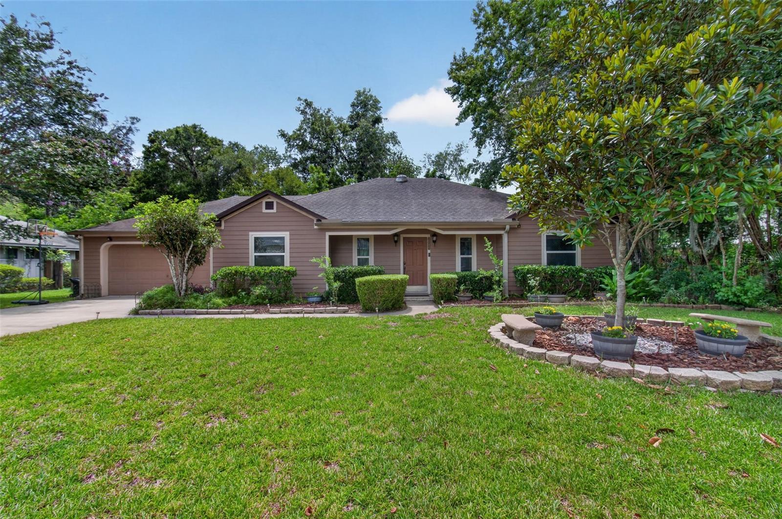 Welcome to Royal Gardens, a top-notch neighborhood located on scenic Glen Springs Road in the heart of northwest Gainesville offering a picturesque and tranquil ambiance just minutes from the University of Florida, Alfred Ring Park and numerous shopping, dining and entertainment venues.  This beautiful, contemporary, pool home offers over 2,000 square feet of living space with 3 bedrooms, a Florida room and 2 full baths. The centrally located great room has a high ceiling, crown molding and French doors leading to the Florida room which overlooks the pool and woods beyond. The kitchen has a pantry, breakfast nook, granite countertops and stainless-steel appliances including a gas oven/range.  The primary bedroom has a walk-in closet and luxury bath with a jetted tub and separate shower. Wood floors are found in all living areas, kitchen and bedrooms. Summertime fun awaits with a beautiful, sparkling pool in the fenced and very private backyard with  a mix of trees and bamboo plus a walking trail on this almost half-acre lot!