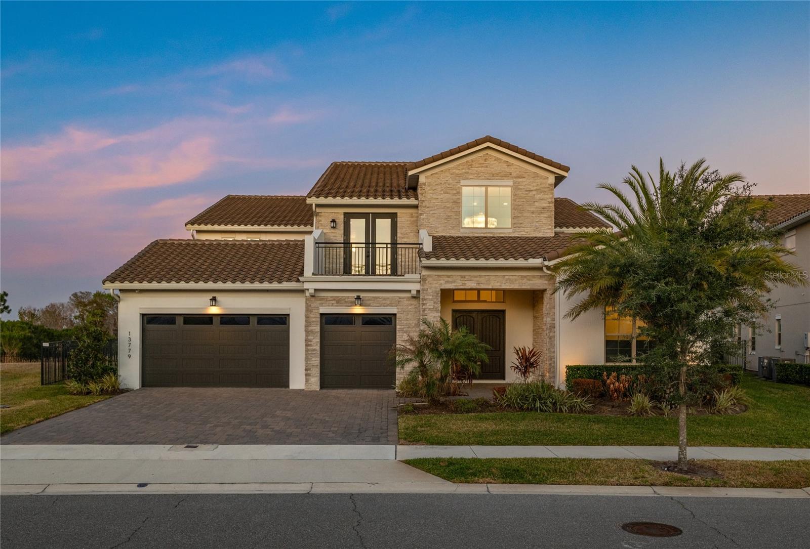 Nestled within the 24-hour guard-gated golf community of Eagle Creek in the heart of Lake Nona, this extraordinary custom residence stands in a category entirely its own. From the moment you step through the front entry, the sculptural red oak staircase with horizontal metal rod railing, rich Greystone Hickory hardwood floors, and soaring ceilings set the tone for the exceptional finishes that await throughout this one-of-a-kind home. The chef's kitchen is a culinary masterpiece, anchored by a Dacor 48" dual fuel range with griddle, four-door French door refrigerator, three dishwashers, microwave drawer, and four wine fridges. Custom Level 5 stacked-upper cabinetry, a Calacatta Novello quartz island with waterfall edge, and a full-height matching backsplash create a kitchen designed for those who entertain at the highest level. The primary suite is a true sanctuary, featuring Serendra Luna polished tile floor-to-ceiling throughout the shower surround and vanity walls, a Kohler Stargaze soaking tub, rain shower head, custom his-and-hers vanities, and a gas fireplace with onyx surround that glows warmly from both the bedroom and the bath. For entertaining, this home has no equal. The dedicated sports bar features custom cabinetry, a double waterfall-edge quartz island, under-counter wine chillers, and a dedicated ice maker. A private gym with mirrored walls and custom built-ins, an executive den with floor-to-ceiling custom cabinetry, and a whole-home RH lighting and AV package complete an interior that is as functional as it is stunning. Step outside to your own private resort, where a custom pool and spa anchor a covered lanai with summer kitchen pre-plumb and a second-floor balcony perfect for enjoying Florida evenings. Eagle Creek is one of Central Florida's premier guard-gated golf communities, featuring a 4.5-star championship 18-hole course, the Belfry Restaurant, resort-style pools, fitness center, tennis courts, and A-rated Lake Nona schools. All of this just minutes from Medical City, Orlando International Airport, and the Lake Nona Town Center. Don't miss your opportunity to own this truly exceptional home and schedule your private tour today.