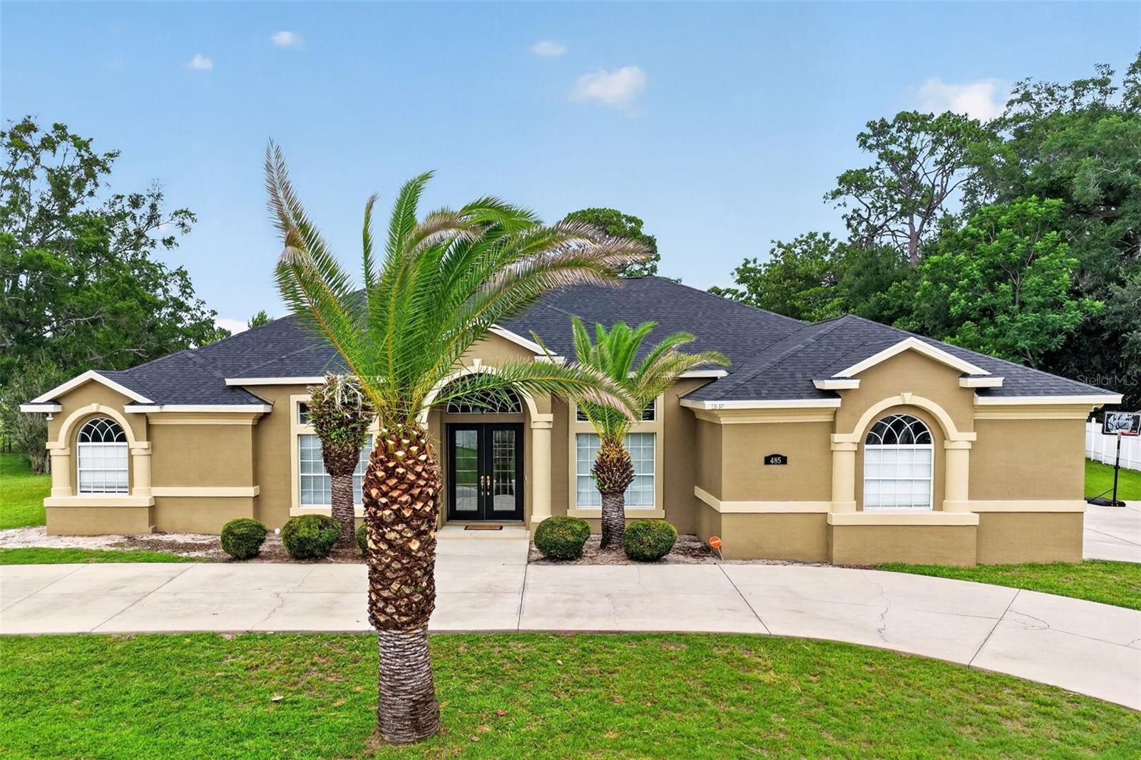 Welcome to this stunning Triple Crown home loaded with upgrades and exceptional features. This spacious 4-bedroom, 3-bathroom home with a 3-car garage offers an open and inviting floor plan with vaulted ceilings, a desirable split-bedroom layout, and beautiful architectural details throughout.  The gourmet kitchen features granite countertops, a center island, and ample cabinet space, all flowing seamlessly into the bright and spacious living areas. Elegant wood flooring, 14-foot doorways, decorative arches, and exquisite molding showcase the craftsmanship and attention to detail found throughout the home.  The luxurious home offers a spa-like retreat with dual vanities, walk-in closets, and an oversized walk-in shower. Generously sized secondary bedrooms provide comfort and flexibility for family and guests.  Step outside to your private backyard oasis featuring a screen-enclosed patio, in-ground swimming pool, and hot tub, perfect for entertaining or relaxing year-round.  As one of the largest homes in the community, this spectacular residence is move-in ready and offers the perfect combination of luxury, comfort, and style. Don’t miss the opportunity to make this exceptional home yours!