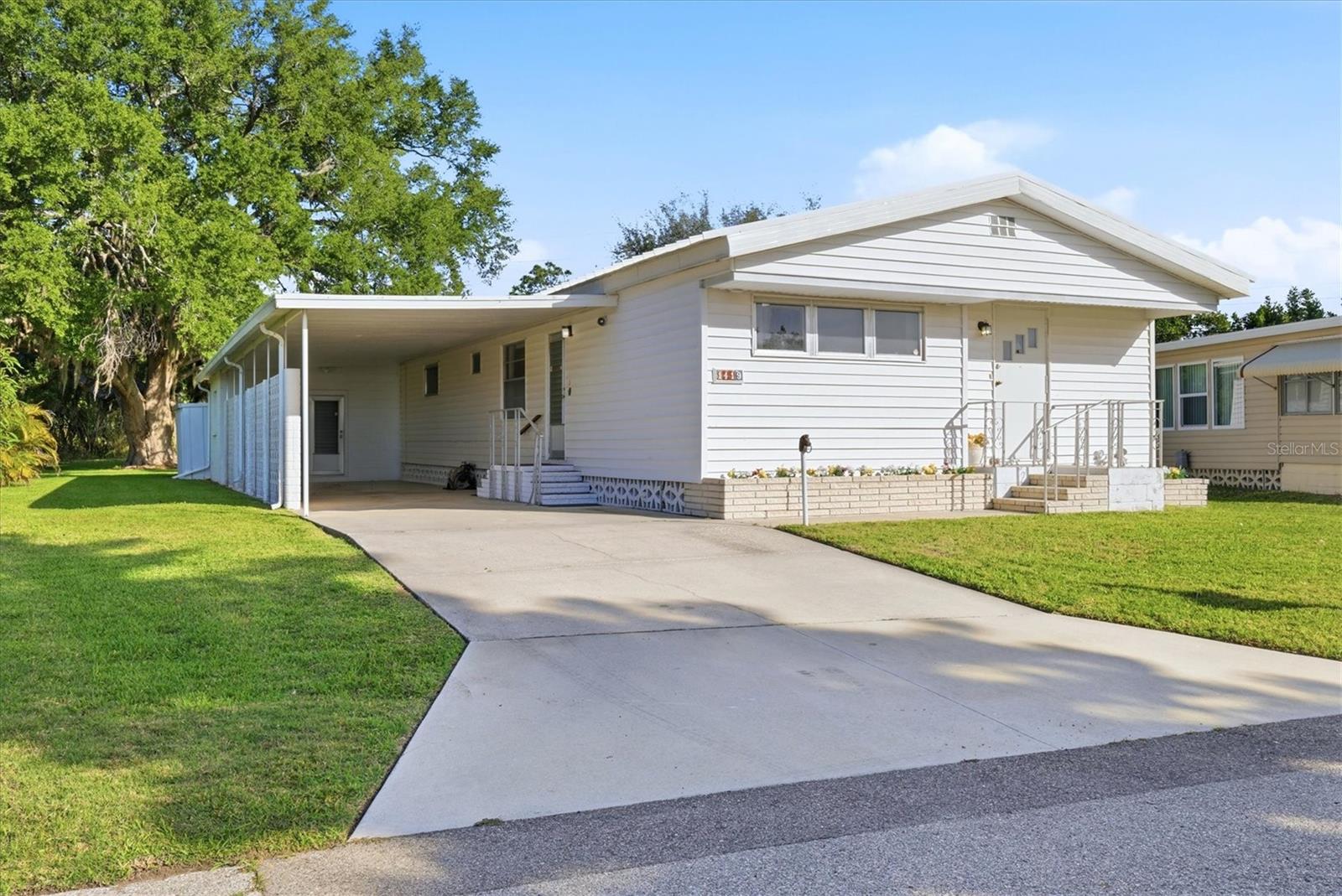 Welcome to Tidevue Estates, a sought-after land-owned 55+ active community offering comfort, style, and Florida charm. This beautifully maintained home features a private backyard shaded by a stunning mature Florida live oak tree—perfect for relaxing or enjoying nature.
Major updates provide peace of mind, including a brand-new roof (2026) and a 3-year-old A/C system. Inside, the open floor plan creates a bright and inviting atmosphere, ideal for both everyday living and entertaining. The chef’s dream kitchen offers abundant cabinetry, a functional island with storage, and ample workspace. The dining room is highlighted by a lovely bay window and built-in cabinetry, adding both charm and convenience. The living room features new carpet, updated sofas, and vaulted ceilings, with additional space perfect for a home office or flex area. Retreat to the spacious primary bedroom, complete with an extra-large walk-in closet. Outdoor and storage space is plentiful, including a block shed with washer and dryer plus workshop, as well as an additional shed in the backyard for garden tools.
Enjoy the Florida lifestyle by creating your own outdoor living room under the expansive carport, with plenty of room to park two vehicles.
This home offers the perfect blend of comfort, functionality, and serene outdoor living—schedule your showing today!  Low HOA of only $600 annually. Pets are not permitted. Plenty of activities to keep you busy in this community. Updated fitness center. Meet friends and make new ones for a game of indoor pickleball, bocce ball, or shuffleboard. Join the Golf League. Take a bike or golf cart ride to Veterans Park to watch the wildlife and enjoy the sunset. Ellenton Premium Outlet Mall, restaurants, and medical facilities are just minutes away. Easy access to I-75 to explore Sarasota. Not to mention a short drive to our beautiful Gulf Beaches.This well-maintained, stylishly updated home is ready for its next owner. Don’t miss this opportunity—move in and start enjoying the Florida lifestyle today!