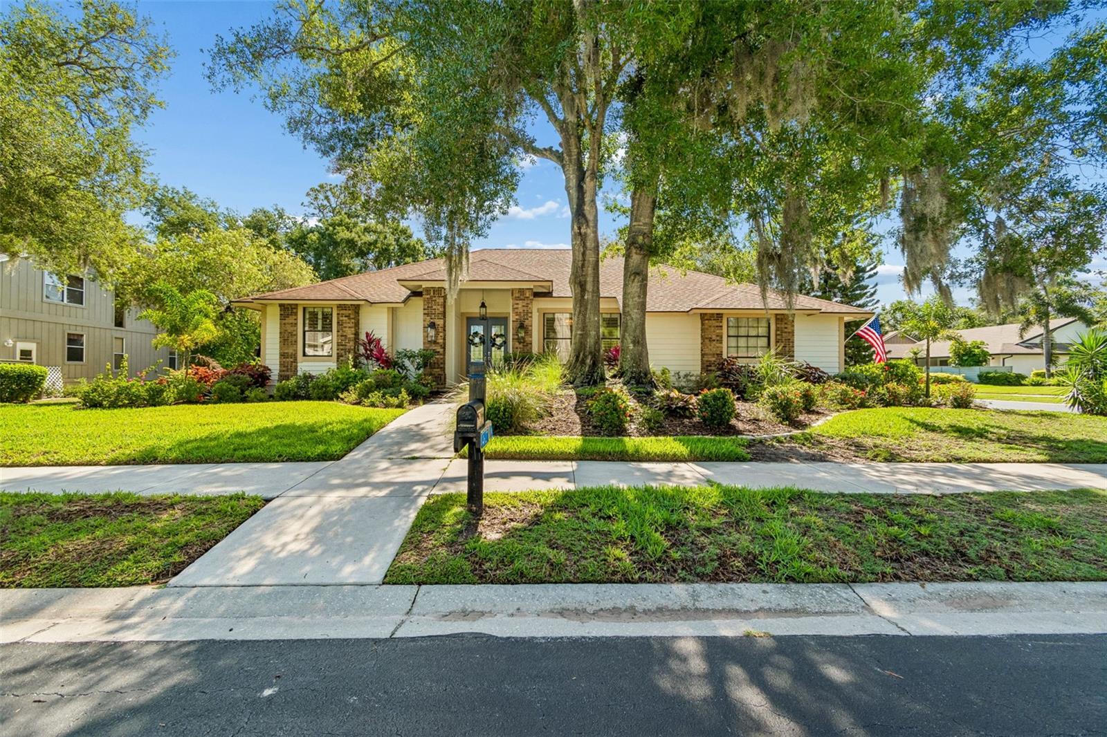 Completely reimagined and perfectly positioned on an oversized corner lot, this exceptional Sarasota residence blends timeless elegance with modern luxury in one of the area's most sought-after communities. Nestled beneath a canopy of mature trees in The Lakes Estates, this fully renovated Lee Wetherington home offers an effortless combination of sophisticated design, spacious living, and outdoor amenities.

Designed for both everyday comfort and entertaining, the open-concept floor plan features 3 bedrooms plus a private office/flex room, soaring volume ceilings, expansive living and dining spaces, and four sets of floor-to-ceiling sliding glass doors that fill the home with natural light. The stunning chef's kitchen is the centerpiece of the home, showcasing an oversized 9-foot island, natural stone countertops, custom cabinetry, stainless steel appliances, decorative tile backsplash, a built-in wine bar with beverage refrigerator, and elegant designer finishes throughout.

The luxurious primary suite offers a peaceful retreat, while beautifully renovated bathrooms feature custom cabinetry, premium stone countertops, and timeless finishes. New ceramic tile flooring, fresh interior and exterior paint, updated lighting, decorative plantation shutters, and a striking electric fireplace further elevate the home's refined coastal aesthetic.

Step outside to your private backyard oasis featuring an oversized screened lanai, sparkling heated saltwater pool, expansive pool deck, and lush tropical landscaping—creating the perfect setting for year-round Florida living. A side-entry two-car garage with epoxy flooring, abundant storage, and extensive landscape enhancements complete this move-in-ready home.

Located in the highly desirable The Lakes Estates, residents enjoy low HOA fees and exceptional amenities including a lakeside clubhouse, resort-style pool, fitness center, tennis courts, scenic walking paths, and beautifully landscaped streets—all just minutes from world-renowned Gulf beaches, downtown Sarasota, UTC shopping, fine dining, golf, and the area's celebrated arts and cultural attractions.