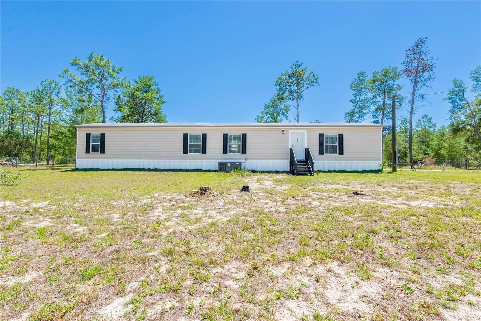 Welcome to country living with room to breathe in beautiful Williston, Florida! This 2022 mobile home features 3 bedrooms, 2 bathrooms, a carport, storage shed and sits on a fully fenced 1-acre corner lot — perfect for pets, outdoor living, and enjoying the peaceful lifestyle Levy County is known for.
You’re just minutes from everything that makes Williston such a hidden gem. Enjoy nearby attractions like Devil’s Den, Blue Grotto, Cedar Lakes Woods & Gardens, and Goethe State Forest for horseback riding, hiking, diving, and outdoor adventures. Plus, you’re conveniently close to local restaurants, grocery stores, feed stores, schools, downtown Williston events, and only a short drive to Ocala, Gainesville, and the World Equestrian Center.

Whether you love the small-town charm, outdoor recreation, equestrian lifestyle, or just want space and privacy without being far from town — this property offers the best of North Central Florida living.