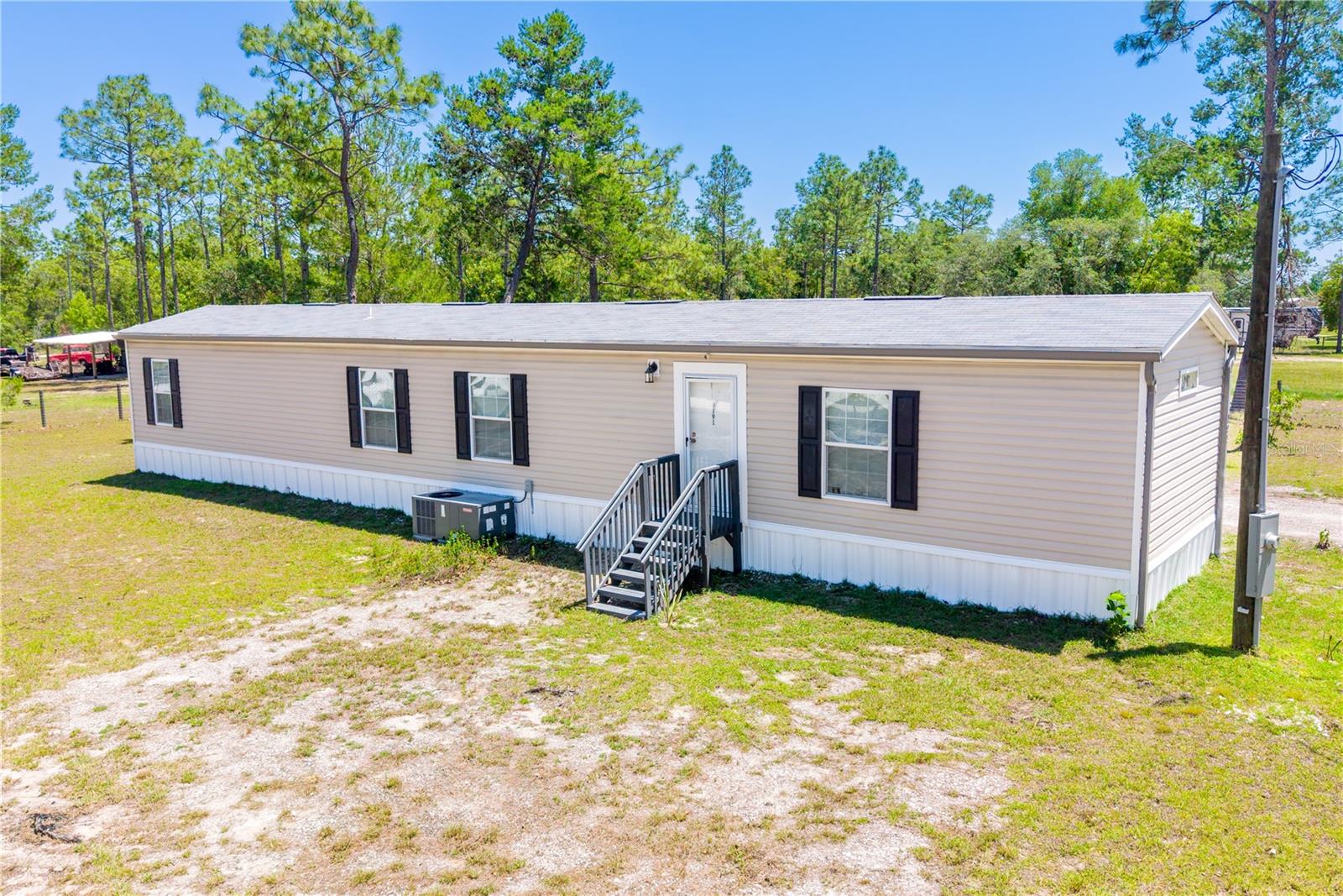 Welcome to country living with room to breathe in beautiful Williston, Florida! This 2022 mobile home features 3 bedrooms, 2 bathrooms, a carport, storage shed and sits on a fully fenced 1-acre corner lot — perfect for pets, outdoor living, and enjoying the peaceful lifestyle Levy County is known for.
You’re just minutes from everything that makes Williston such a hidden gem. Enjoy nearby attractions like Devil’s Den, Blue Grotto, Cedar Lakes Woods & Gardens, and Goethe State Forest for horseback riding, hiking, diving, and outdoor adventures. Plus, you’re conveniently close to local restaurants, grocery stores, feed stores, schools, downtown Williston events, and only a short drive to Ocala, Gainesville, and the World Equestrian Center.

Whether you love the small-town charm, outdoor recreation, equestrian lifestyle, or just want space and privacy without being far from town — this property offers the best of North Central Florida living.