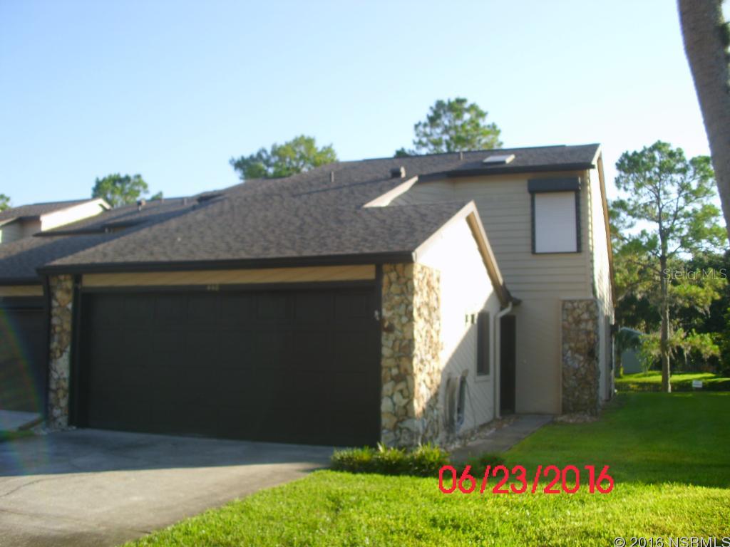 HIDDEN PINES COMMUNITY, excellent location in New Smyrna Beach! Close to I-95, shopping, downtown and the beach!  Community features include community pool, tennis court, shuffleboard.  2 story townhome, double garage with washer & dryer for your convenience.  2 master suites-1 downstairs and loft/master suite upstairs plus half bath downstairs.  Rustic feel in living area with fireplace within beautiful coquina wall, new wood laminate flooring, brand new carpet, new paint.  Kitchen has tons of cabinets and large pantry.  Screened porch over looking pond. No Smoking.
