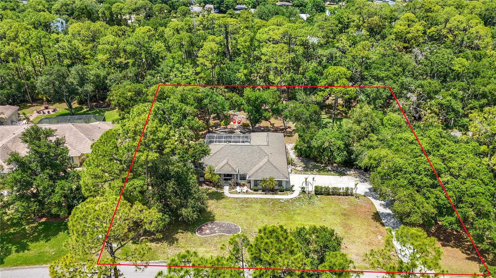 Rarely does an opportunity arise to own one of the most expansive and private estates in the coveted Mill Creek community.  This exceptional home spans nearly an acre and a half of lush land, offering a level of tranquility and space that is increasingly hard to find.  Situated in a preferred X flood zone (no insurance required), the massive lot is a true sanctuary, bordering no neighbors directly in the front or rear and sitting just across from a serene, rarely-used private park.  The home itself carries a legacy of care and thoughtful design, featuring three spacious bedrooms and two and a half beautifully renovated bathrooms.  The interior radiates elegance with soaring vaulted ceilings, while the floor plan emphasizes convenience with generous walk-in closets in every single bedroom.  outdoor kitchen that features a built-in grill, sink with hot and cold water and refrigerator is ready for all your pool and backyard entertaining. The kitchen has custom granite countertops with cabinets, a breakfast bar and pantry. The floors boast either new laminate flooring or tile for easy maintenance and clean up. The spacious Master bedroom has French doors leading to the patio and pool area, new laminate floors, separate his and her walk-in closets that lead to the Master Bathroom. The Master Bathroom features a new stylish, stand-alone soaking tub, separate shower and dual sinks. Cathedral ceilings and pocket doors help make this home feel spacious. The 2nd and 3rd bedrooms feature large walk-in closets and new laminate floors. New stainless kitchen appliances and tankless hot water heater.  A standout feature of the property is the large enclosed garage, which provides not only secure parking but also tons of storage for all your work or organizational needs.  The vast acreage ensures that the potential here is truly limitless.  Whether you envision a massive, detached RV garage, a professional-grade workshop, or secondary utility structures to protect your toys from the elements, there is more than enough room here to build your dreams.   Entertaining is effortless on this estate, which features a sprawling driveway capable of accommodating up to 24 vehicles for gatherings.  The outdoor living space is highlighted by an inviting martini pool and a dedicated grill area, perfect for hosting weekend parties or enjoying quiet Florida evenings in the shade of nature.  Despite the immense size and privacy of the lot, the property remains governed by low HOA fees and no CDD ensuring the neighborhood's beauty is preserved without high overhead.  Beyond the property lines, Mill Creek offers a lifestyle of unparalleled convenience and A rated schools.  You are positioned within easy reach of the world-renowned Beaches of Anna Maria Island and Siesta Key, while the nearby Lakewood Ranch Main Street and University Town Center provide premier shopping and dining.  With swift access to I-75 and the Sarasota-Bradenton International Airport, commuting to Tampa or St. Pete is a breeze.  This is more than just a house; it is a sprawling canvas ready for its next chapter.  Schedule your private tour today to experience the scale and serenity of Mill Creek’s finest.  Professional Photos coming soon.