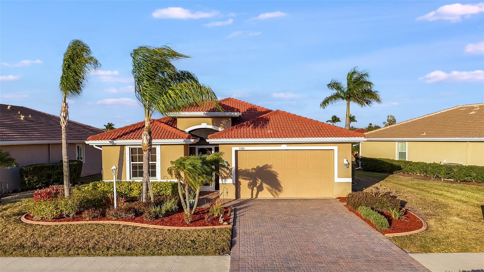 3D VIRTUAL TOUR Welcome to Talon Bay, a gated, active-lifestyle community surrounded by more than 100 acres of lush landscaping, sparkling lakes, and protected nature preserves. This beautifully designed residence offers the perfect blend of resort-style amenities and peaceful Florida living, all just minutes from the best of Wellen Park and the Gulf Coast. From the moment you arrive, the tropical curb appeal sets the tone. Mature palms, manicured lawn, decorative curbing, and colorful plantings frame the home, while the screened front porch provides a welcoming entry. Inside, over 1,900 square feet of thoughtfully planned living space unfolds with high ceilings, graceful archways, rounded corners, and an open floor plan designed for both comfort and entertaining. The gourmet kitchen is the heart of the home, featuring stainless steel appliances, granite countertops, solid wood cabinetry with decorative molding, recessed lighting, and a closet pantry. A large center island with breakfast bar and pendant lighting overlooks the spacious Great Room, creating an ideal gathering space for family and friends. The adjoining dining area offers lovely views and the perfect place to enjoy morning coffee or evening meals. The primary suite is a private retreat with tray ceilings, dual walk-in closets, and tranquil lake and preserve views to start each day. The spa-inspired ensuite bath includes a Roman walk-in shower with built-in bench, garden tub, dual sinks, makeup vanity, and private water closet. Bedrooms two and three are located on the opposite side of the home, each with ceiling fans, ample closet space, and luxury vinyl flooring, with a well-appointed guest bath conveniently between them. A versatile den with French doors can serve as a fourth bedroom, home office, craft room, or media space. Triple cascading sliders open to an oversized screened lanai where indoor and outdoor living blend seamlessly. Backing to a lake with preserve, this peaceful setting is perfect for birdwatching, outdoor dining, or relaxing with an evening drink while enjoying Florida water and wildlife from your own backyard. Do you need anymore reasons to love this home? How about this peace of mind - Hurricane shutters and a 17.5kw wired portable generator being included in the sale! Talon Bay offers exceptional amenities including a clubhouse with fitness center, heated resort pool, tennis courts, covered grilling area, kayak and canoe launch to Myakkahatchee Creek, and miles of scenic walking and biking paths winding around six lakes and 15 acres of preserved land. With low HOA fees and no CDD, this community provides outstanding value. Ideally located just minutes from Downtown Wellen Park, CoolToday Park, Venice Beach, Manasota Key, championship golf, dining, and shopping, this home delivers the perfect balance of convenience and natural beauty. Experience a lifestyle you will truly love.