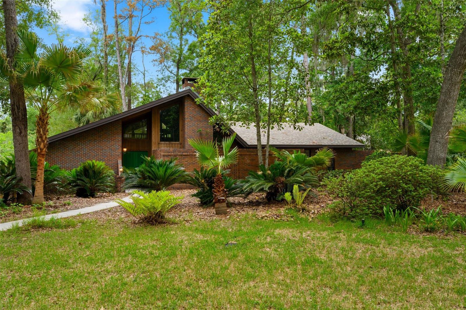 Nestled among the mature trees of Emerald Woods, one of Gainesville's most beloved established neighborhoods, this beautifully renovated home offers the rare combination of a serene, wooded setting with unbeatable everyday convenience. Every major system and finish has been thoughtfully updated, giving the next owner true peace of mind from day one. New AC, new water heater and roof is 2014. Step inside and you'll find new luxury vinyl plank flooring flowing seamlessly throughout, fresh interior paint, and an atmosphere that feels bright, clean, and move-in ready. The heart of the home is a fully reimagined kitchen — outfitted with crisp white cabinetry, gleaming quartz countertops, and stainless steel appliances. Whether you're hosting friends or enjoying a quiet morning coffee, it's a space designed to impress and perform. Updated bathroom vanities complete the picture of a home where no detail was overlooked. Outside your door, everything Gainesville has to offer is within easy reach. I-75, Publix, and area shopping are just minutes away, and you're within a 15-minute drive to the University of Florida and UF Health — ideal for faculty, staff, medical professionals, or anyone who values a central location without sacrificing neighborhood character. Homes this move-in ready, in a setting this special, don't last. Schedule your private showing today.