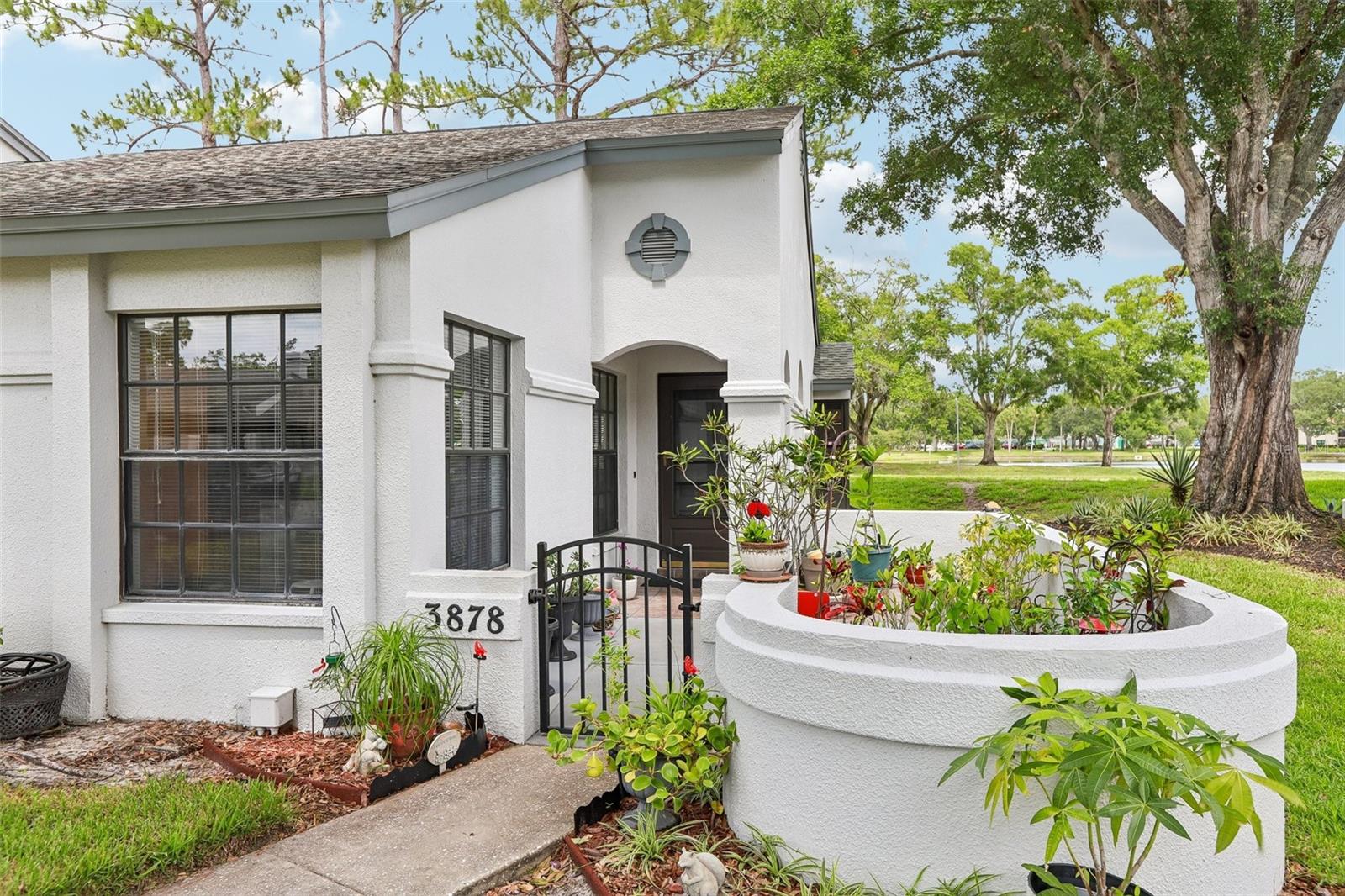 This highly desirable, end-unit villa offers a wonderful view of Crystal Lake and the adjacent park, combining comfortable living with a prime location. The interior features three bedrooms, two bathrooms, and spacious living areas enhanced by crown molding, with durable ceramic tile flooring in the beds and baths and stylish laminate throughout.  Relax in the enclosed lanai or enjoy community amenities that include a pool, a clubhouse, and hassle-free exterior and landscaping maintenance, alongside one dedicated covered parking spot. Perfectly positioned along the East Lake corridor, the property provides quick driving access to grocery stores, local dining, the historic Tarpon Springs Sponge Docks, and regional Gulf beaches, while sitting within just one mile of John Chesnut Sr. Park—a popular local destination on Lake Tarpon known for hiking, boat ramps, and wildlife viewing.