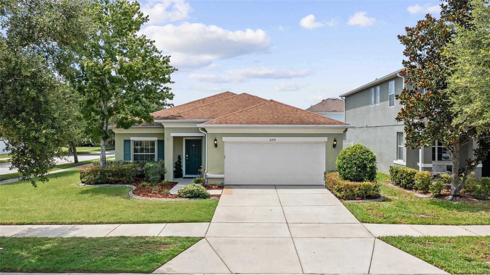 Gated Luxury Living in Stonebrier! Perfectly positioned on a lush oversized corner lot in the highly sought-after gated community of Stonebrier, this beautifully maintained Pulte/Centex Sonora model offers the perfect blend of timeless style, everyday comfort, and exceptional Florida living. Built in 2013, this thoughtfully designed one-story home features 4 bedrooms, 2 bathrooms, a 2-car garage with built-in shelving and attic storage, and 2,070 sq ft of well-planned living space. Outstanding curb appeal begins with manicured landscaping, classic shutters, coach lighting, and a charming portico entrance. Step inside to a welcoming tiled foyer that opens to engineered hardwood flooring throughout the main living areas, enhanced by elegant crown molding that adds warmth and sophistication.  At the heart of the home, the spacious kitchen is designed for both everyday living and entertaining. Rich dark wood cabinetry with crown molding and staggered heights is paired with a tile backsplash, granite countertops, stylish pendant lighting, a walk-in pantry, and a complete appliance package. A curved counter-height breakfast bar overlooks the spacious family room, creating the perfect gathering place for family and friends. Recessed lighting and crown molding complete this inviting living space. The adjoining café area opens through sliding glass doors to a covered lanai featuring two ceiling fans and beautiful paver stone flooring, which extends to an expansive paver patio overlooking the fully vinyl-fenced backyard. Whether hosting family gatherings, grilling with friends, or enjoying a quiet morning coffee, this outdoor living space is designed to be enjoyed year-round. The private primary suite offers a relaxing retreat with crown molding, a ceiling fan, a spacious walk-in closet, and an ensuite bath featuring a dual granite-topped vanity, a seamless glass-enclosed tiled shower, a garden tub with tile surround, and a linen closet. A desirable split-bedroom floor plan provides privacy for three additional generously sized bedrooms, each featuring plush carpeting, ceiling fans, and ample closet space. The secondary bathroom includes a double granite-topped vanity, single undermount sink, and tub/shower combo. A spacious indoor laundry room with cabinetry and a utility sink adds everyday convenience. Families will appreciate the home's location within the highly regarded Steinbrenner High School, Martinez Middle School, and McKitrick Elementary School. Stonebrier offers an exceptional resort-style lifestyle with amenities that include a zero-entry swimming pool with a waterslide, a clubhouse with a fitness center, poolside cabanas and lounge areas, playgrounds, and athletic fields for soccer, basketball, and cricket, all surrounded by scenic lakes, ponds, and conservation areas. Ideally located in Lutz, this home offers easy access to the Veterans Expressway, Dale Mabry Hwy, SR 54, and I-75, placing Downtown Tampa, Tampa International Airport, and the Gulf beaches within convenient reach. Enjoy being just minutes from premier shopping, a wide variety of restaurants, medical offices, major hospitals, parks, and everyday conveniences, all while living in the privacy and security of the highly sought-after gated community of Stonebrier. With an unbeatable location, this beautifully maintained Stonebrier home offers the perfect setting to enjoy the Florida lifestyle. Don't miss this incredible opportunity—schedule your private showing today!