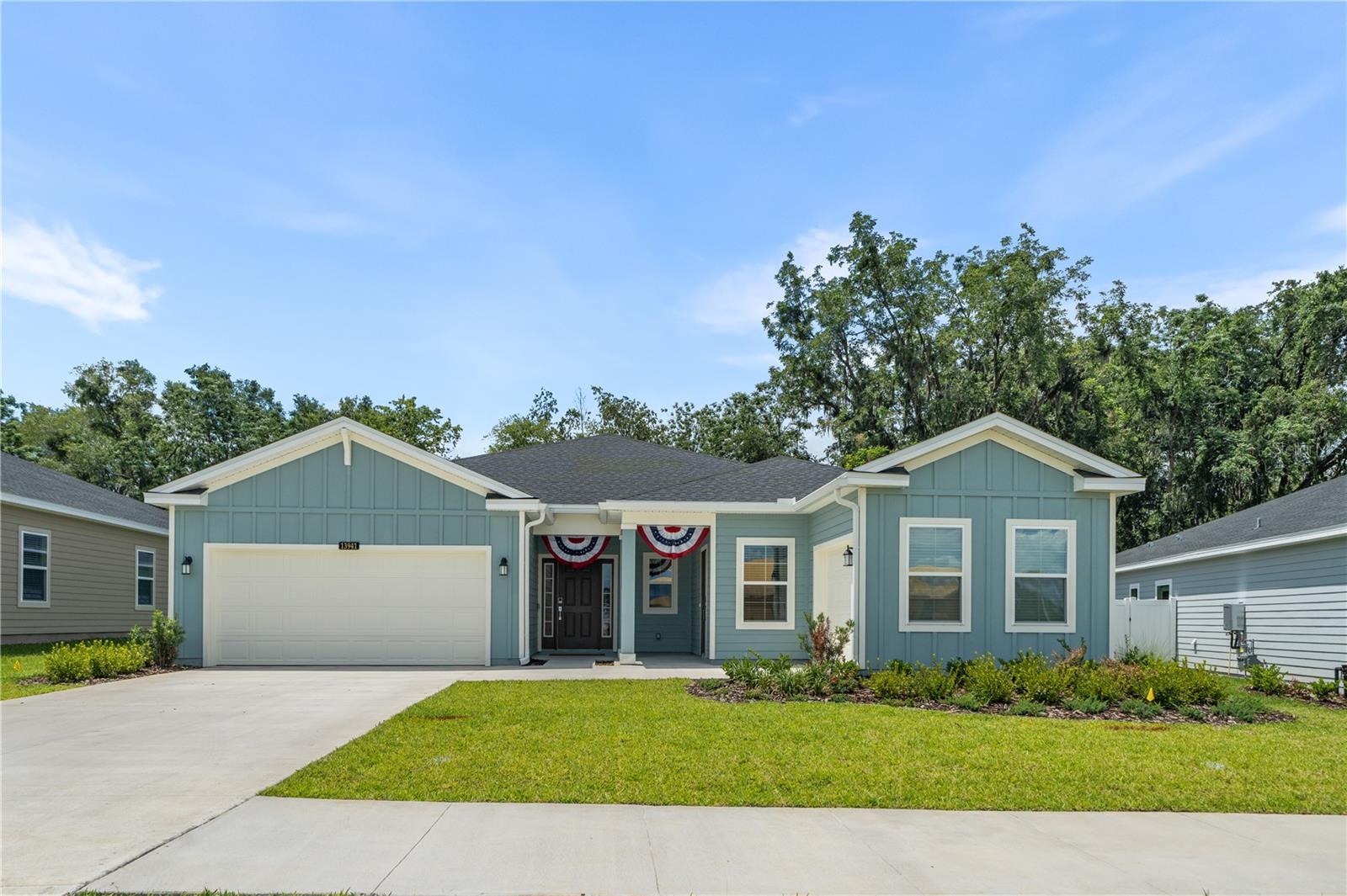 This Beautiful brand new home on a premium lot welcomes you in and greets you with a light and airy feel and expansive open space. This floor plan is ideal for the large family, or multi-generational living with a separate living area and second kitchen, a large private bedroom and full bath. The space could be used for a second family or a home theater or a space for the family to hang out as a large flex space. Or use it as a studio or home business with a separate entrance. Besides four bedrooms there is a large room with French doors and closet for an office or home Gym or could be a 5th bedroom. The home features cool and easy to clean, neutral, ceramic tile floors throughout all the main living areas and the front entry foyer flows seamlessly into the great room making it the ideal space for gathering with friends and family. The primary suite has a huge walk in closet with a custom cabinet system and the ensuite bath has dual vanities, soaker tub and separate shower. The spacious kitchen features a huge island with with deep sink and solid surface counters and bar seating and spacious dining room perfect for entertaining large groups. The glass doors open onto screen porch and home backs up to private space so No homes behind you! The homeowner has completed all the needed updates with custom lighting and custom closet organizers. All appliances stay including two Refrigerators, oven and gas range, built in microwaves, dishwashers and washer/dryer. A second laundry closet hook up for extra washer/dryer or you could have a utility sink for studio or a portable sauna! The neighborhood of Trail Head Landing is so Convenient with two entrances; from 441 you easily access UF or Downtown Gainesville and from 241 you can access Newberry Road and West Side of Gainesville for Hospitals or Shopping. I-75 is just as convenient to head north or south. Take advantage of Alachua Farmers market and Quaint Downtown Alachua for restaurants and shopping. Just outside the community is San Felasco State park where you can enjoy miles of nature trails for biking and hiking. It really is a great location to be able to enjoy Pool, Park and Playground amenities and new construction that is move in ready. There is also a third garage/storage for multiple uses including your own workshop! Owners are relocating and can give quick occupancy and can offer some of the beautiful furnishings to you too. It couldn't be easier. Just bring your suitcases and get ready to enjoy your new lifestyle with easy care living.