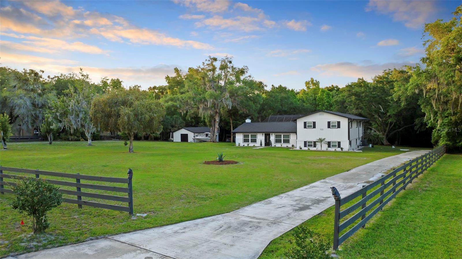 Welcome to your own private retreat, where resort-style outdoor living meets flexibility, space, and stunning upgrades.

Set on a massive 1.68-acre lot with a peaceful creek running along the back, this property delivers a rare park-like setting filled with majestic mature trees and wide-open space to relax, entertain, and unwind. The showstopper? A beautiful pool paired with an oversized screened-in patio, perfect for hosting, lounging, and enjoying that indoor-outdoor Florida lifestyle year-round.

Step inside and you’ll find a home that’s been thoughtfully upgraded with modern, high-end finishes. The kitchen is a standout, featuring brand-new quartz countertops, stylish new cabinetry, and sleek stainless steel appliances, all designed to impress while still being functional for everyday living. A cozy wood-burning fireplace adds warmth and character, while multiple living and dining spaces give you flexibility to live exactly how you want.

And then there’s the ultimate bonus: a fully separate lower-level living space with its own private entrance and full second kitchen. Whether you’re looking for multi-generational living, guest quarters, or income potential, this setup is a total game changer and incredibly hard to find.

Upstairs, the primary suite offers a spacious retreat with its own flex area, perfect for a home office, nursery, or private lounge and even includes direct access down to the pool area. The additional bedrooms are generously sized, making this home as practical as it is beautiful.

Big-ticket upgrades are already handled, including a BRAND NEW ROOF (2026), newer windows, and HVAC, giving you peace of mind from day one.

Properties with this kind of land, privacy, upgrades, and built-in versatility don’t come around often. If you’ve been waiting for something special, this is your moment.

Schedule your private showing today before it’s gone.