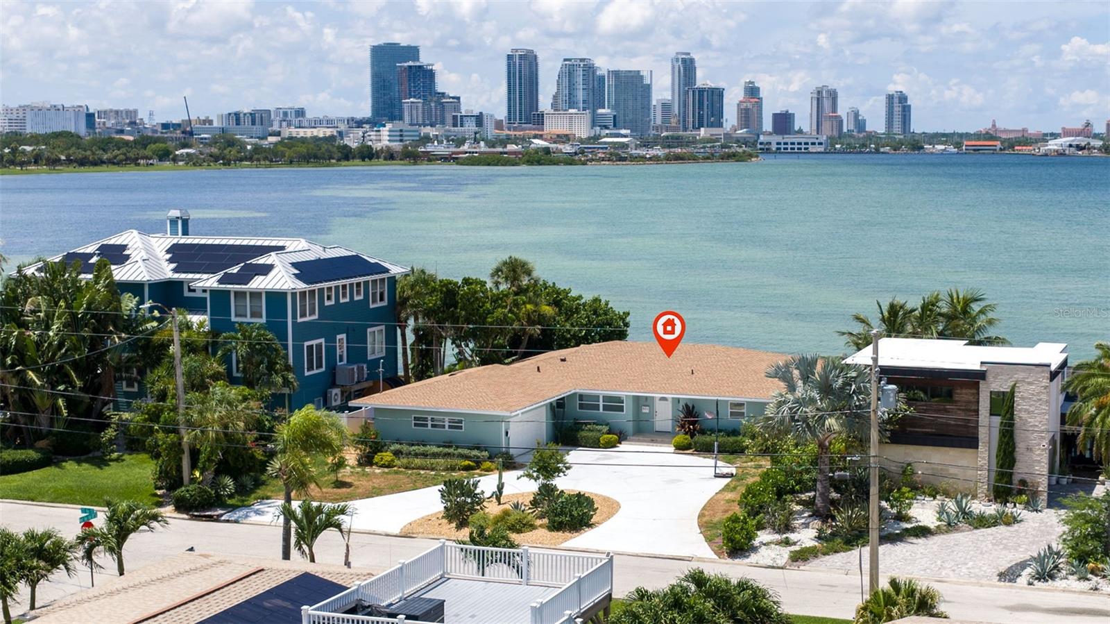 WATERFRONT HOME BLOCK CONSTRUCTION WITH 80 FEET OF OPEN TAMPA BAY FRONTAGE, DOWNTOWN ST. PETE VIEWS & COMPLETE 2024 RENOVATION. Located in the Tropical Shores neighborhood of St. Petersburg, this single-story waterfront residence offers 80 feet of unobstructed Tampa Bay waterfront with panoramic views of the downtown skyline and direct boating access to open water with NO BRIDGES. Thoughtfully renovated in 2024, the home combines modern finishes with a functional ranch-style layout in one of the city's most convenient waterfront locations.
The open floor plan connects the living room, dining area, kitchen, and waterfront sunroom, creating a seamless flow while maximizing natural sunlight and expansive water views throughout the main living spaces. The sunroom functions as an additional sitting area, home office, or den, all overlooking Tampa Bay and the St. Petersburg skyline.
The kitchen was COMPLETELY RENOVATED IN 2024 with solid wood soft-close cabinetry, quartz countertops, an oversized island with bar seating, GE stainless steel appliances, and a generous walk-in pantry. The waterfront primary suite enjoys skyline views, a spacious walk-in closet, and an updated en-suite bathroom featuring dual vanities and a walk-in shower. Two additional bedrooms share a fully renovated guest bathroom.
MAJOR IMPROVEMENTS COMPLETED IN 2024 include a NEW ROOF, NEW HVAC SYSTEM, UPDATED PLUMBING, UPDATED ELECTRICAL, DOUBLE-PANE WINDOWS, LUXURY VINYL FLOORING, AND COMPLETELY RENOVATED KITCHEN AND BATHROOMS, allowing buyers to move in with confidence.
The backyard is designed to take full advantage of the waterfront setting with ample room for a future pool, outdoor kitchen, or expanded entertaining space while preserving unobstructed views across Tampa Bay. Additional features include reclaimed water irrigation, a circular driveway, two-car garage, and block construction.
Located less than half a mile from Lassing Park, residents enjoy easy access to paddleboarding, kayaking, waterfront walking paths, dog-friendly green space, and some of St. Petersburg's most beloved outdoor destinations. Downtown St. Petersburg, Beach Drive, the St. Pete Pier, Harborage Marina, restaurants, shopping, and I-275 are all just minutes away, while St. Pete Beach is approximately 15 minutes from the property.
This home offers a rare combination of OPEN TAMPA BAY WATERFRONT, PANORAMIC DOWNTOWN ST. PETERSBURG VIEWS, A COMPLETE 2024 RENOVATION, AND SINGLE-STORY LIVING in one of St. Petersburg's most desirable waterfront neighborhoods.