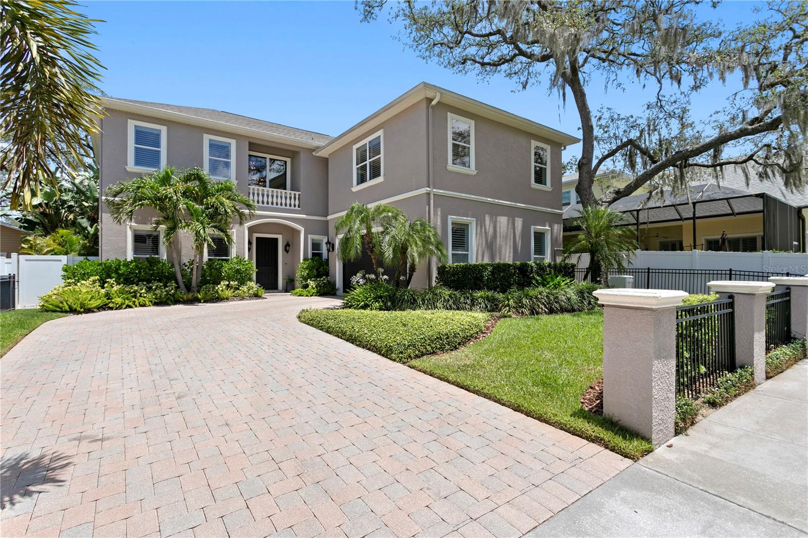 Virtually Staged. Situated on a beautifully elevated homesite in one of South Tampa’s most desirable neighborhoods, this stunning transitional Mediterranean residence seamlessly blends timeless architecture with sophisticated modern living and ideal entertaining space. Offering 4 bedrooms, 3.5 bathrooms, and an exceptional collection of recent designer renovations, this home delivers the perfect balance of elegance, comfort, and functionality.

Thoughtfully updated throughout, the entire first floor has been transformed with exquisite attention to detail, including a beautifully redesigned chef’s kitchen, spacious living room, elegant dining room, private office, stylish wet bar, and refined powder bath. The luxurious primary suite has also been completely renovated, creating a serene retreat highlighted by a spa-inspired bathroom and sophisticated finishes.

Designed for effortless indoor-outdoor living, the backyard rivals a private resort. A heated saltwater pool and spa feature a sun shelf with resort-style loungers, while the fully equipped outdoor kitchen includes a grill, beverage refrigerator, and oversized umbrella canopy for year-round entertaining. Lush tropical landscaping, professional outdoor lighting, and a full irrigation system create a breathtaking setting both day and night.

Constructed with quality and longevity in mind, this exceptional home offers 20’ elevation, dual-pane impact windows, plantation shutters, custom wood blinds, a whole-home generator, and the peace of mind that comes with high-quality construction and a central location outside of a flood zone.

Combining luxurious renovations, resort-style outdoor living, and an unbeatable South Tampa neighborhood, with high elevation, no flood zone location, impact windows and whole-home generator, this is a rare opportunity to experience the very best of Florida luxury living.