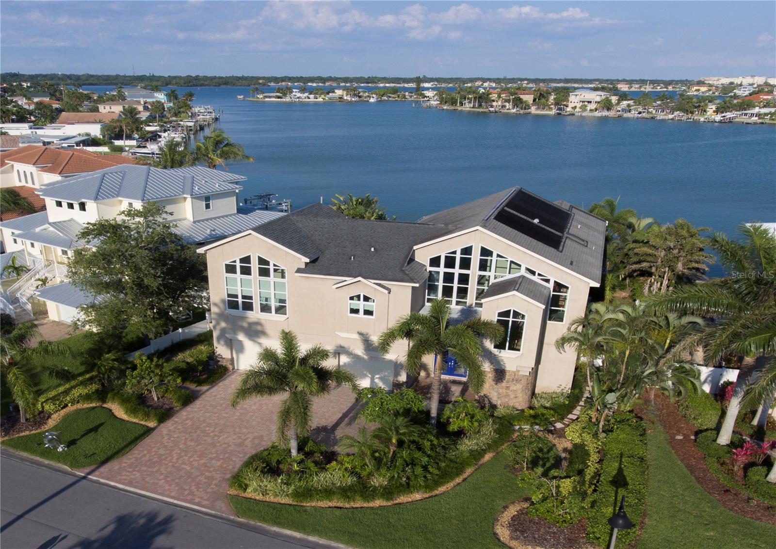 A TRUE RARITY! THIS LARGE, LUXURIOUS WATERFRONT HOME IS AVAILABLE FOR LONG-TERM LEASE. OVERLOOKING BEAUTIFUL WIDE WATER, THIS EXHILLARING NEO-CONTEMPORARY ARCHITECTURAL MASTERPIECE DELIVERS A DRAMATIC & SINGULARLY INSPIRING LIVING EXPERIENCE! Past lush landscaping & a towering stone facade entry, you'll be awed by soaring 35ft-high ceilings & a massive living area w/big, bold water views & wonderful natural lighting. Marble, porcelain & Brazilian Redwood flooring integrate w/seamless clarity. Fabulous chef’s kitchen boasts dazzling granite counters and superb free-form bar area w/matching ceiling that casts rich, subtle coastal overtones. 2 luxurious master suites offer fine closets, superb waterviews and lavish full baths with porcelain/granite/marble/wood finishes. Handsome gas fireplace, exceptional office with luxurious mahogany built-ins and outstanding oval built-in entertainment center. Upper level feels like a trip thru a Modern Art Museum – with ceiling, wall and window contours offering brilliant, complementary shapes and towering geometric forms that will leave you speechless. Upper-level bedrooms/living areas are tied together by an amazing 960+ sqft wrap around deck – all overlooking the water. Out back, discover a resplendent private oasis with Pebbletec pool/spa, posh built-in gas cooking center and multi-function deep water dock with 24,000 lb and 7,000 lb boat lifts, paddleboard/kayak storage and electric drydock launch. Solar panels, tankless hot water, 4 zone AC, electronic window shades and so much more! Just a 3-minute walk to the beach.