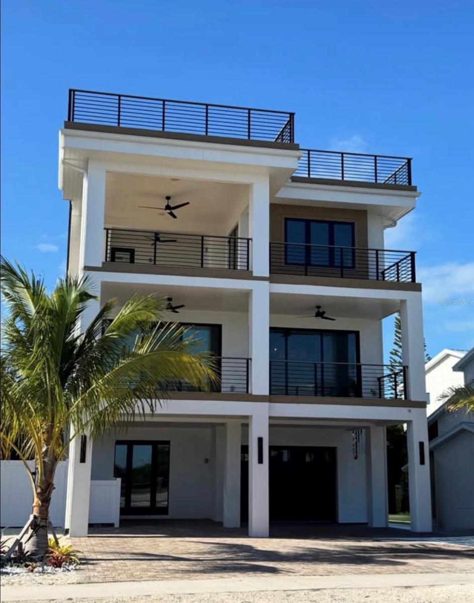 Under Construction. Custom Canal-front home underway by Salt Wave Construction, ideally located just a stroll from Siesta Key Beach and Village. 
Built entirely with solid block construction, this home showcases high-quality materials throughout, including hurricane-impact windows. Designed with durability in mind, its island-style construction ensures lasting strength and resilience.Thoughtfully designed to maximize its waterfront setting, the home showcases expansive porches and a spectacular rooftop deck spanning the entire roofline, offering panoramic views of the wide canal and surrounding Siesta Key landscape.
This approximately 3,000-square-foot home features 4 spacious bedrooms, each with its own en-suite bath, delivering both comfort and privacy. The primary suite is a true retreat, boasting a luxurious oversized bathroom, an expansive walk-in closet, and a private canal view loggia with a fireplace—perfect for relaxing evenings.
Crafted with a seamless blend of sophisticated design and high-quality finishes, this residence provides an unparalleled sanctuary. The outdoor living space includes an open pool area, ideal for entertaining, unwinding, or enjoying direct access to Sarasota’s scenic waterways.
Located just minutes from world-renowned white sand beaches, vibrant dining, shopping, and entertainment, this home perfectly balances tranquility and convenience in one of Sarasota’s most desirable neighborhoods.
Estimated completion: approximately 10-12 months.