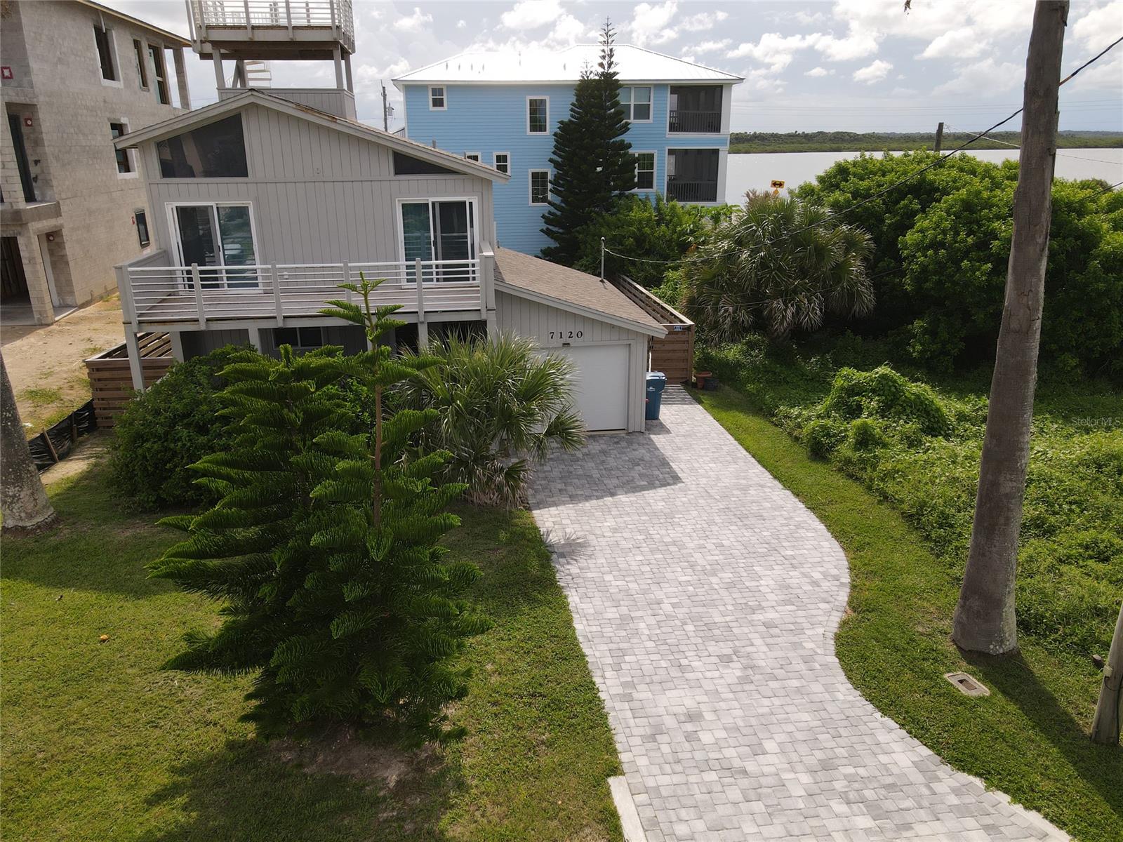 Unique opportunity to purchase a completely remodeled home on a much sought after street in exclusive Bethune Beach with spectacular ocean/river views. 6 spacious decks on 4 levels total more than 1032 additional sq feet and offer amazing sunrise to sunset views. Beach access walk over ramp directly across the street leads to one of the most beautiful, NO DRIVE beaches on the island. This expansive, open & contemporary floor plan was totally renovated between 2015 to 2020 with no expenses spared. Light and bright in every room with soaring ceilings throughout. Remodel included new kitchen (GE appliances) & solid wood cabinets, Cali solid bamboo floors throughout, exterior/interior paint,  completely renovated bathrooms, all new windows & sliders, fireplace, decks, fire sprinkler system, fire/alarm system, mini split a/c,  garage door, paver driveway, outdoor shower,  patio and fence. Large lot with fully fenced backyard. No outlet/dead end street on the scenic southern most point of NSB. This area of Bethune does not allow short term rentals, has no public parking and is a quiet residential neighborhood with no HOA. Steps away from Canaveral National Seashore and river banks for paddle boarding and dolphin viewing.  Vacant 50 x 100 ft. adjacent wooded corner lot directly north is available for purchase (399K) also which would encompass a massive 100 x 100 property. ;Water: City