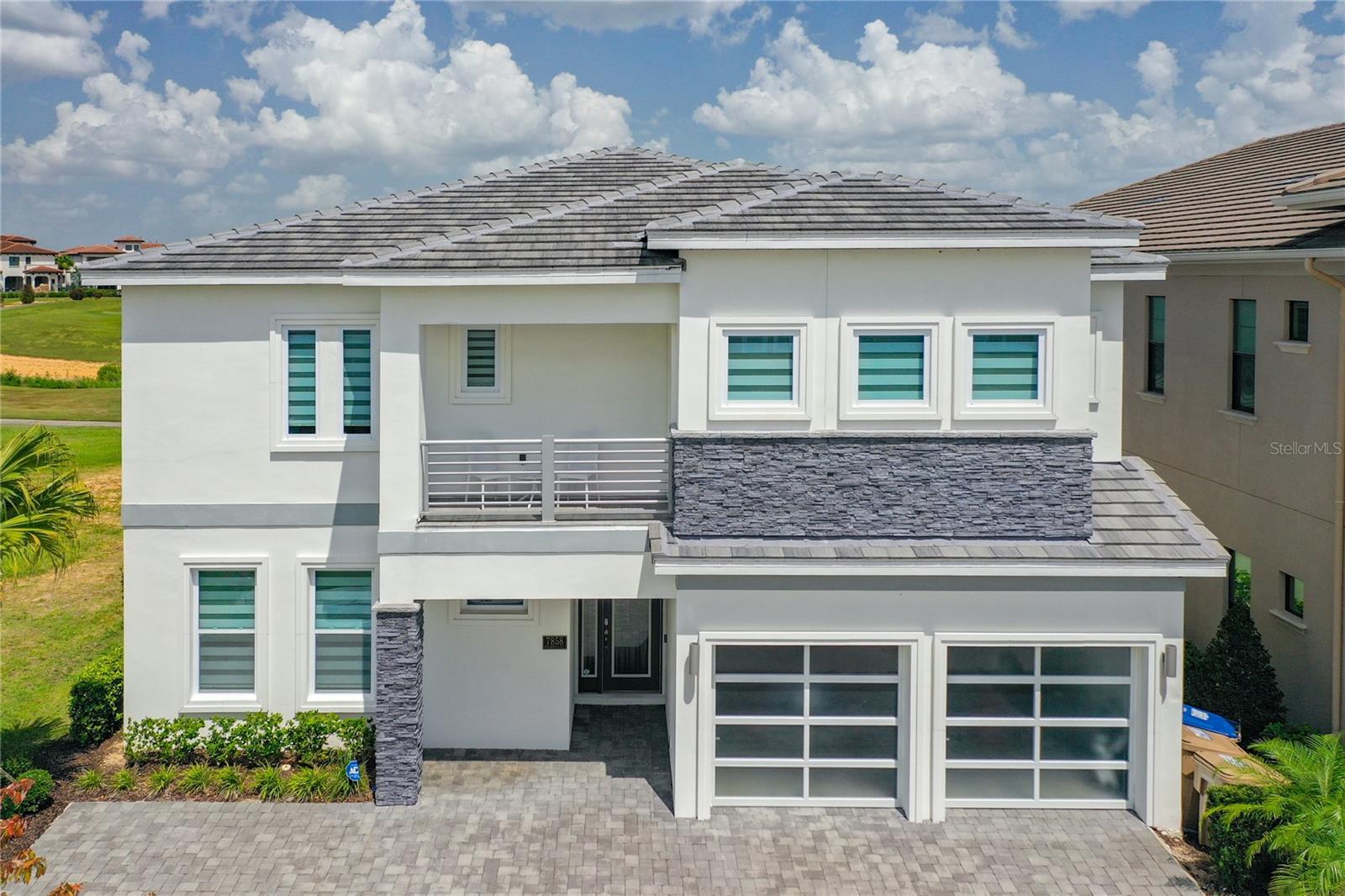 CONSIDER ALL THE POSSIBILTIES of this FULLY FURNISHED 11 bedroom, 11.5 bath, GOLF frontage home, perfectly placed on a quiet cuddle-sac in the spectacular Reunion Resort. Full of potential as an investment property or personal vacation retreat and ready to fulfil your vision and needs…. Professionally decorated, masterfully designed, and graced with sweeping golf course views of the 11th hole of the Nicklaus, this open concept floor plan excels at comfortably accommodating large numbers of guests with upper and lower gathering sections, a spacious, well-equipped kitchen, dining area, and covered outdoor living space with a summer kitchen that opens out to the pool and spa. Pride of Ownership throughout! The primary suite has a luxurious bathroom and is one of three bedrooms located on the first floor for convenience and accessibility. In addition to the remaining bedrooms, the second floor features the Media Room, Gym, Laundry, and an Entertainment Rec Room with Card Table, Arcade Game, Billiards Table, Dual Nascar Racing Machines and an extra-long Wet Bar with a refrigerator, beverage cooler and abundance of cabinetry. Other notable mentions: Bar Top Seating, Catering Island, Specialty Ceilings, Designer Lighting, Granite Countertops, Porcelain Flooring, Custom Blinds, Energy Efficient Windows, Smoke Detectors, Ceiling Fans, Front and Rear Balconies, Two Laundry Rooms, Pool Bath, Tile Roof, Paver Driveway and Pool Deck and a Garage that can be converted into usable space. Ample parking. Extremely Valued TRANSFERABLE MEMBERSHIP can potentially convey! Reunion Resort and Club is a GATED, GOLF community designed for the active lifestyle with 3 signature golf courses, tennis center, WATERPARK, 11 communal pools, playgrounds, putt putt golf, Spa, fitness center, arcade, DOG PARK and numerous on-site dinning choices. It is also a short-term rental community for additional advantages. Convenient to Central Florida's major roadways, attractions, dining, shopping and beaches! This home has never been in the rental pool and is around the corner from the back guard gate for quick access to Hwy 429 and I-4. A TURNKEY opportunity that is ready to go whether for your own purposes or as an addition to your investment portfolio. Come see why Reunion is a unique one-of-a-kind community and a coveted place to own!