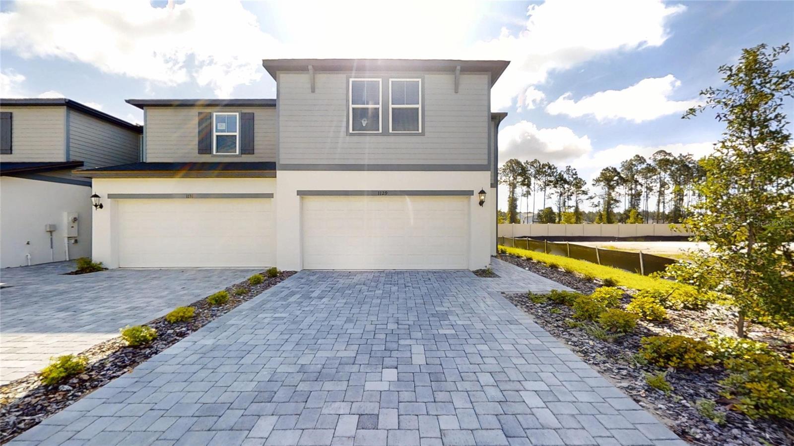 Welcome to 1129 Bradford Park Drive, a brand-new energy-efficient end-unit townhome available for rent in the highly  Bradford Park community of Ormond Beach. Offering 3 bedrooms, 2.5 bathrooms, 1,808 square feet of thoughtfully designed living space, a two-car garage, and a paver driveway, this move-in-ready residence combines modern style with everyday convenience. The open-concept main level features a spacious great room, dining area, and a beautifully designed kitchen with luxury cabinetry, quartz countertops, a large center island, stainless steel appliances, and abundant natural light throughout. Upstairs, a versatile loft provides the perfect space for a home office, media room, or play area, while the private primary suite offers a spacious walk-in closet and en-suite bath. Two additional bedrooms, a full bathroom, and a convenient laundry room with a full-size washer and dryer complete the second floor. Residents enjoy access to resort-style community amenities including a pool and cabana, pickleball courts, basketball court, playground, and scenic water features. Ideally located just minutes from I-95, US-1, shopping, dining, medical facilities, top-rated schools, and the beautiful beaches of Ormond Beach, this exceptional rental opportunity offers the perfect combination of comfort, convenience, and low-maintenance Florida living. Available for immediate occupancy.