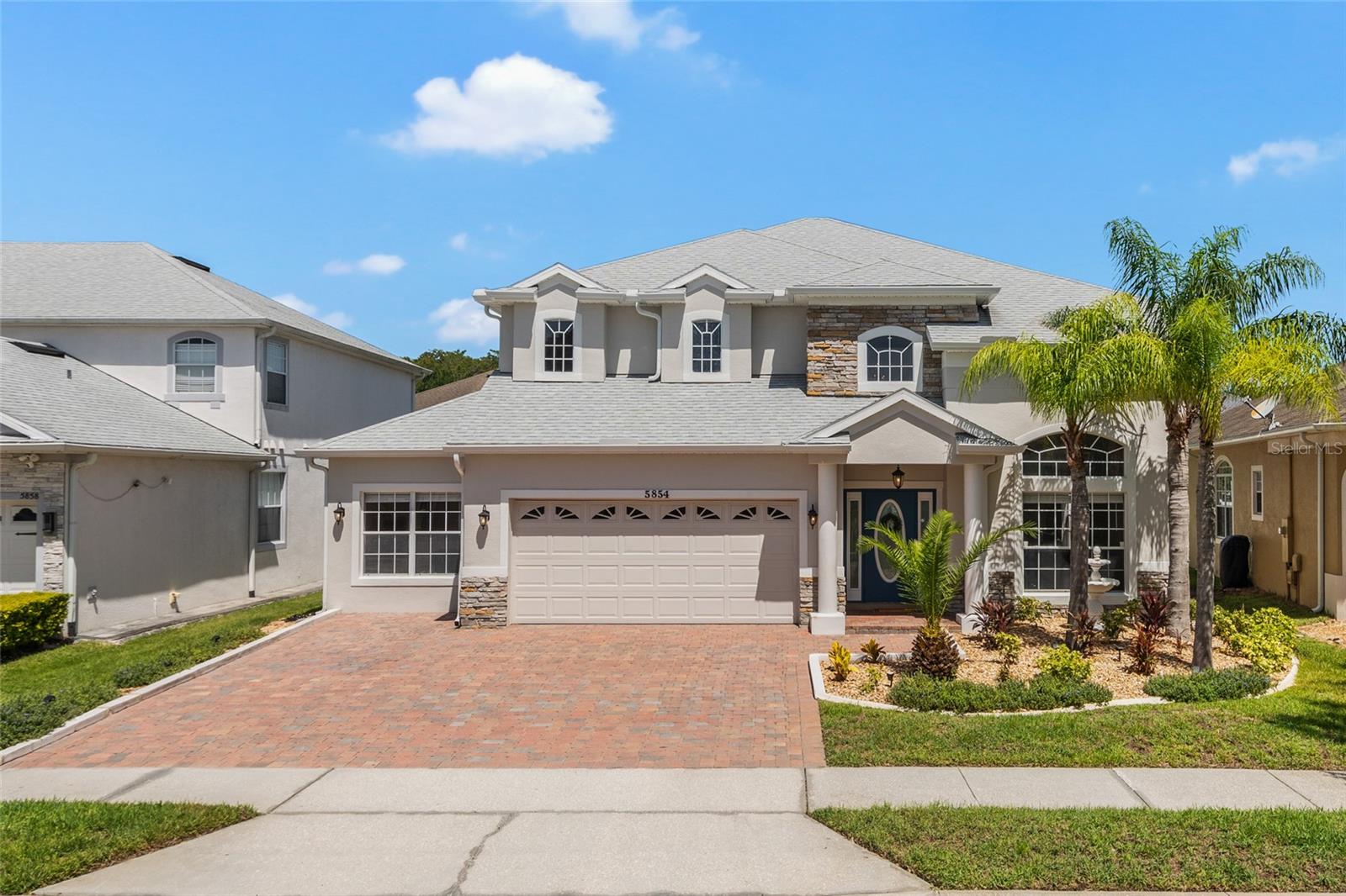 Welcome Home! This move-in ready Vista Lakes home showcases spectacular curb appeal and a highly functional, versatile floor plan designed for today's lifestyle. Featuring 5 bedrooms, 3 full bathrooms, formal living and dining rooms, a spacious loft, a two-car garage, a NEW ROOF (2023), and NEWER AC (2022), this home truly has it all.

As you enter, you'll immediately appreciate the soaring ceilings, welcoming foyer, expansive windows that fill the home with natural light, and the beautiful engineered hardwood and tile flooring that flow throughout the home. Just off the entryway are the formal living & dining rooms, offering the perfect spaces for hosting holidays, dinner parties, or create additional flex spaces to fit your needs.

At the rear of the home, you'll discover the heart of the home—a cozy family room, kitchen, and dining nook thoughtfully designed for everyday living and effortless entertaining. The kitchen features stainless steel appliances, a center island with breakfast bar, upgraded cabinetry with glass-front accents and crown molding, a stylish mosaic glass tile backsplash, a closet pantry, & a single-basin sink.

Adjacent to the kitchen is a bright and inviting dining nook surrounded by large windows that overlook the expansive backyard, creating the perfect setting to enjoy your morning coffee or family meals.

The spacious family room is enhanced with beautiful crown molding and oversized sliding glass doors that open to the covered and screened lanai, creating seamless indoor-outdoor living and the perfect place to enjoy Florida's year-round sunshine.

Tucked away at the rear of the home, you'll find a generously sized walk-in laundry room, two secondary bedrooms, a full bathroom, & convenient access to the two-car garage, making this layout ideal for guests or multigenerational living.

Let's head upstairs where you'll find an impressive loft featuring custom built-in shelving, a cozy fireplace, upgraded wrought-iron staircase railing, and additional crown molding throughout the upstairs. Whether used as a second living area, media room, game room, or home office, this flexible space offers endless possibilities.

Your spacious primary suite welcomes you through elegant French doors & offers plenty of room to relax & unwind. Complete with its own fireplace, this private retreat also features an en-suite bathroom with dual vanities, a soaking tub, walk-in shower, & a generously sized walk-in closet.

Two additional bedrooms and an upgraded full bathroom complete the second floor, providing comfortable accommodations for family and guests.

Step outside to enjoy the large fenced backyard offering abundant green space for pets, play, or the opportunity to design your dream pool and outdoor oasis. An additional paver patio located just beyond the screened lanai creates the perfect spot for grilling, entertaining, or gathering with family and friends. Lastly, the two-car garage provides ample parking along with plenty of additional storage space, completing this exceptional home in one of Orlando's popular communities. The Vista Lakes Village community provides an exceptional lifestyle with an array of top-tier amenities. Residents have exclusive access to the clubhouse, a sparkling community pool perfect for a hot Florida day, a playground, a fully-equipped fitness center, Tennis Courts, and more. Minutes to shopping, dining, major highways, Orlando International Aiport, and Lake Nona Medical City.