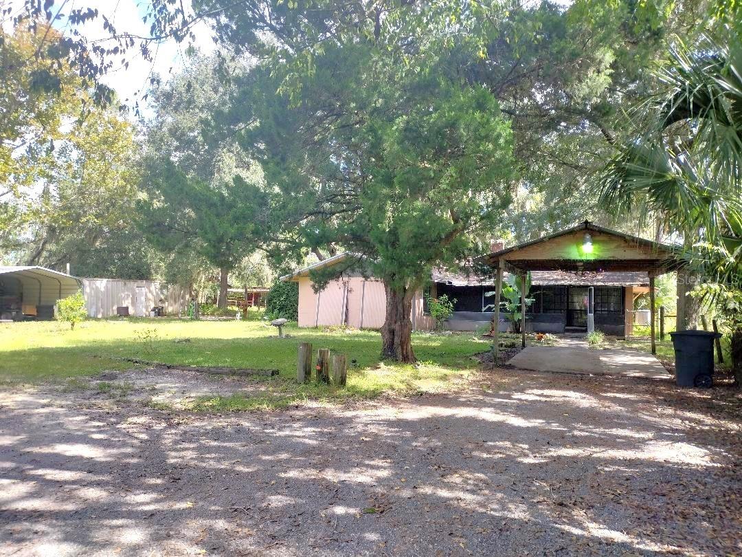 Step back in time with this charming 1962 farmhouse nestled on a fenced 1.5-acre lot zoned Agricultural and adorned with majestic oaks! This 4-bedroom, 1-bath home offers timeless character with wood accent ceilings, two fireplaces, a spacious 18x20 family room, a screened front porch, and an enclosed back porch perfect for relaxing in the peaceful surroundings. Modern updates include a 2018 roof and septic system replaced in 2010. Located on a paved road with city water, just minutes from town, shopping, I-95, and Flagler Beach. Enjoy the best of country living with convenience close by! Don't miss this unique opportunity!