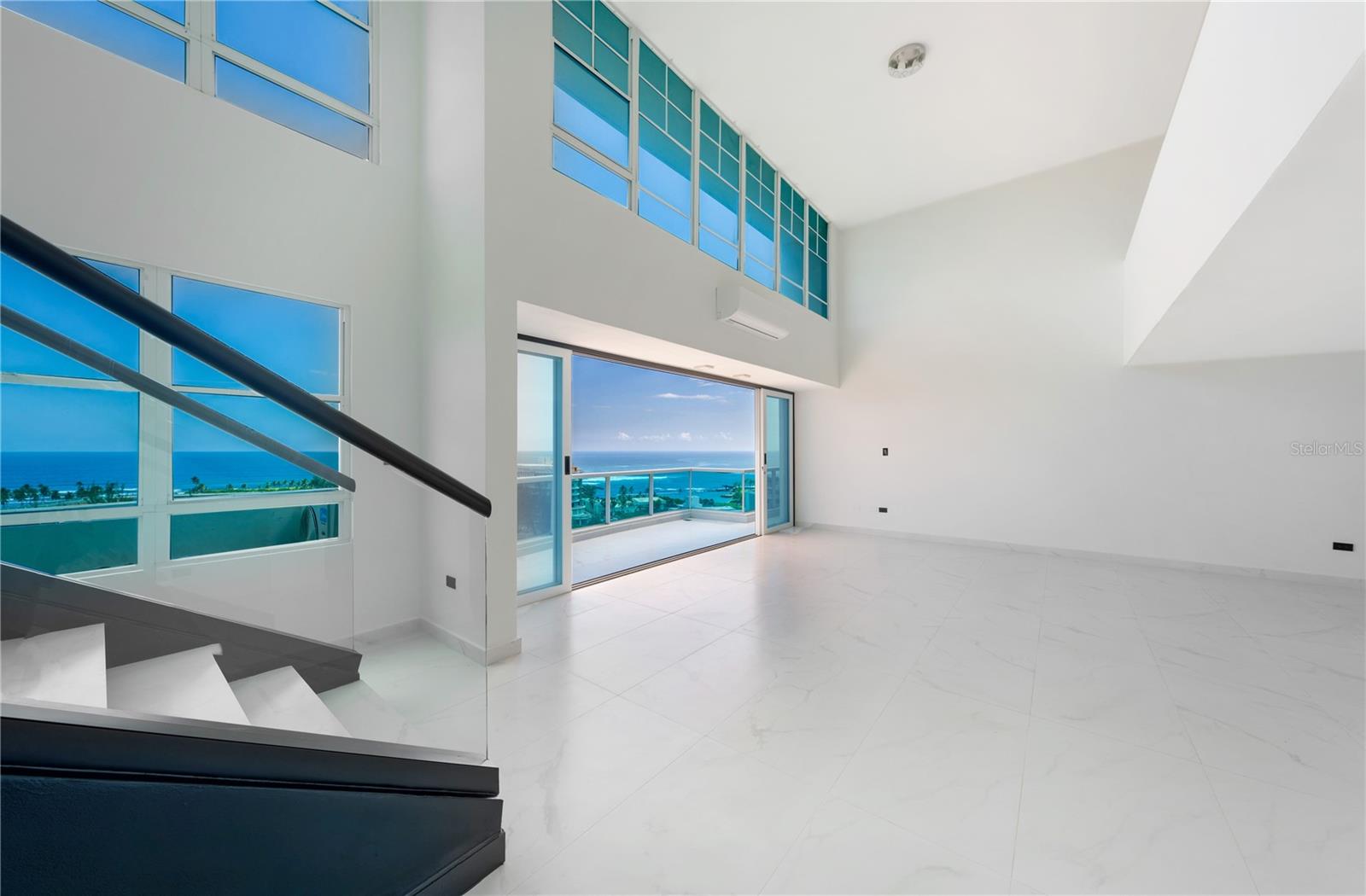 One or more photo(s) has been virtually staged. ***SOLD*** Welcome to your stunning 2-level oceanview penthouse conveniently located in the entrance to Old San Juan. Featuring 3 bedrooms, 3 full baths, and 2 half baths spread over 3,017 total square feet of luxurious living space, including 2,670 Interior and 347 exterior square feet, this is the ultimate in beachside living. Fully renovated in 2023, the condo includes all new electrical, plumbing, fixtures, A/C units, appliances, glass doors and flooring. As you enter the penthouse, you'll be immediately struck by the breathtaking unobstructed ocean views, which can be enjoyed from every room. The spacious and open living area features high ceilings, large windows, and sliding glass doors that lead out to the expansive balcony, where you can enjoy the fresh ocean breeze and watch the waves roll in. This is the perfect spot for entertaining or relaxing with family and friends. The gourmet kitchen is set to be a chef's dream, with top of the line appliances, custom cabinets, and quartz countertops. Upstairs, you'll find a second living area that opens up to the great room below. The primary suite is a true oasis, with its own private balcony overlooking the ocean, a luxurious spa-inspired bathroom, and a walk-in closet. The two additional bedrooms are spacious and enjoy panoramic ocean views. Four dedicated parking spaces, and a private storage room complete this unique property. The building offers 24-hour security and valet services, concierge and guest parking, fitness center and a full power generator. Having recently purchased the adjacent lot, the building has future plans to construct a new gym and pool. Located just steps from the beach and minutes from the vibrant culture and nightlife of San Juan, don't miss your chance to own this incredible oceanfront penthouse. Annual Hazard Insurance: $2,998. Monthly Condo Fee: $1,022. The kitchen, master bedroom and bathroom cabinets shown in photos  6, 7, 8, 13 and 14 are renderings representing exact plans. They are currently being installed, and soon to be completed.