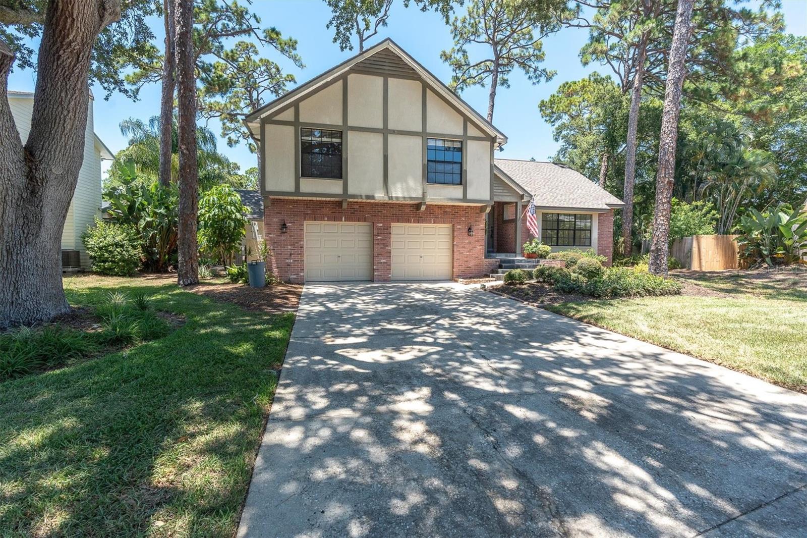 Set on a beautifully landscaped oversized cul-de-sac lot, this spacious 4-bedroom, 3-bath Tudor-style split-level home offers 2,292 square feet of living space plus an additional 572-square-foot oversized two-car garage. Major updates include a new roof (2023) and two A/C units installed in 2021, providing peace of mind for years to come.
The main living level showcases elegant crown molding throughout, a bright and inviting living room, and a formal dining room that can also serve as a flexible bonus space. The spacious eat-in kitchen is designed for both everyday living and entertaining, featuring granite countertops, stainless steel appliances, abundant cabinetry, and two pantry closets for exceptional storage.
Upstairs, the primary suite offers a private ensuite bath complete with a soaking tub/shower and vaulted ceilings. Three additional generously sized bedrooms provide plenty of room for family, guests, or a home office, with one bedroom featuring extensive built-in storage. A large unfinished attic provides even more convenient storage space.
The lower level is perfect for relaxing or gathering with family and friends, offering an expansive family room centered around a cozy fireplace and sliding glass doors leading to the backyard patio. This level also includes a full third bathroom, laundry room, and direct access to the oversized two-car garage with separate garage doors.
The beautifully landscaped oversized lot offers exceptional outdoor space with an expansive driveway, ample room for RV parking or additional vehicles, and plenty of space to add the pool of your dreams. Nestled on a quiet cul-de-sac, this home combines timeless Tudor charm, generous living space, thoughtful updates, and outstanding functionality in a highly desirable setting. Don’t miss this exceptional opportunity to make it yours!