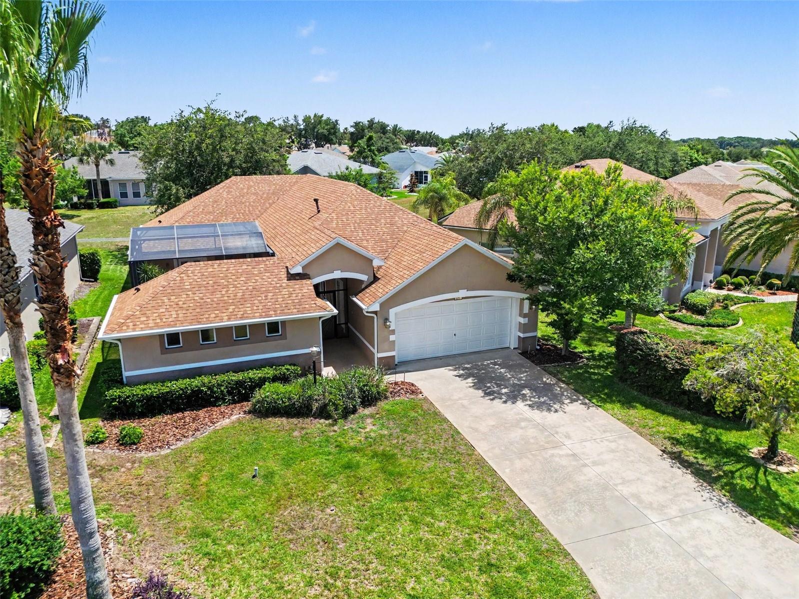 Welcome to this custom Courtyard home in Royal Harbor on the Harris Chain of Lakes! Offering 3 Bedrooms, 3 Baths, and 2,012 Sq. Ft., this light-filled home blends privacy, flexible living space, and Florida indoor/outdoor living beautifully. Centered around a spacious screened Courtyard, the unique layout creates a peaceful retreat ideal for entertaining, relaxing, or hosting guests. A separate Casita/Bedroom 3 with private full bath and closet opens directly to the Courtyard, making it perfect for guests, multigenerational living, hobby space, art studio, home office, or private retreat. Inside the main home, soaring ceilings, abundant natural light, and large windows create an open, airy feel throughout. The Dining Area and Great Room flow seamlessly together and open to the back screened porch through two sets of sliders, bringing the outdoors in. The Kitchen offers abundant cabinetry, generous workspace, Breakfast Bar seating, and a sunny Breakfast Nook overlooking the Courtyard. Privately located at the rear of the home, the spacious Primary Suite features large French doors leading to the backyard, a large walk-in closet with custom built-ins, and an ensuite bath with an expansive dual-sink vanity, soaking tub, and large walk-in shower. Bedroom 2 also includes a walk-in closet with built-ins and easy access to a full bath. The screened Courtyard truly sets this home apart, offering exceptional outdoor living space with room for lounging, dining, gardening, and enjoying Florida’s beautiful weather year-round. The backyard features mature landscaping and peaceful green space, while a nearby path leads to a small lake where residents can enjoy fishing and nature views. NEW HVAC 2026, ROOF 2022.  Located in Royal Harbor, a gated 55+ waterfront community on Little Lake Harris and the Harris Chain of Lakes, residents enjoy a Clubhouse, Heated Pool and Spa, Fitness Center, Pickleball, Tennis, Bocce, Shuffleboard, Billiards, Community Dock, and RV/Boat Storage. Conveniently located near shopping, dining, medical facilities, and charming downtown Tavares. Come experience the unique charm and relaxed Florida lifestyle this special home has to offer!