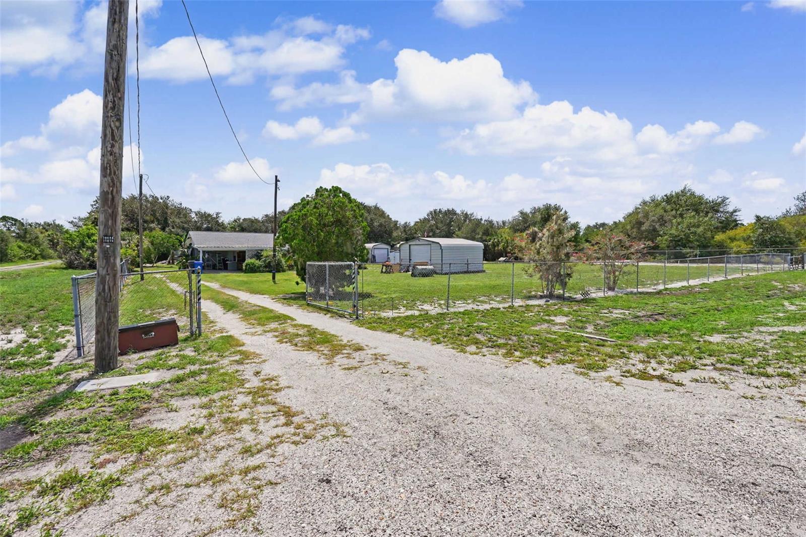 Virtually Staged. A full acre in Hillsborough County with no HOA and no CDD — that combination is nearly gone. This 3-bed, 2-bath SFH sits on one of the last true oversized lots in the area, giving buyers the outdoor footprint that new construction simply cannot replicate. Inside, 1,324 sq ft of comfortable, move-in-ready living flows naturally to the outdoors. A covered carport handles 2+ vehicles with room to spare. Land, privacy, and zero restrictions — buyers who find this understand exactly what they're looking at. Opportunities like this surface rarely. Call now to schedule your showing before it's gone.