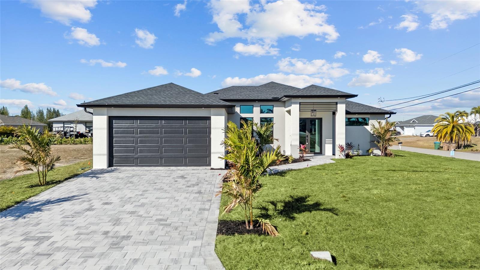 Welcome to this stunning NEW CONSTRUCTION beauty in Cape Coral, sitting on a CORNER LOT and offering over 1,700 sq. ft. of modern luxury with 3 bedrooms and 3 full bathrooms—including a highly desirable pool bath, perfect for when you add your dream pool. From the moment you walk in, you’ll feel how meticulously this home was designed. The tall ceilings with tray LED lighting, and sleek open layout create a bright, airy feel that’s perfect for entertaining. The split floor plan gives everyone their own space and privacy—while still keeping the home open and connected. The kitchen is a showstopper: spacious, modern, and built for real living, featuring a STYLISH BACKSPLASH, SOFT-CLOSE CABINETS, SLEEK STAINLESS STEEL APPLIANCES including built-in MICROWAVE/OVER COMBO and a HOT WATER POT FILLER/WARMER for luxurious convenience. The best features of the home: IMPACT DOORS & WINDOWS, GUTTERS with FASCIA/SOFFIT detailing throughout, MODERN TILE throughout the entire home, Beautiful modern LED LIGHTING details, CONTEMPORARY CHANDELIERS and PRE-WIRED MEDIA WALL, HIS & HERS CLOSETS in the Owner's Suite including FLOOR-TO-CEILING TILE and GLASS ENCLOSURES for a true spa-like feel, Finished landscaping for curb appeal from day one, EPOXY FLOORING in the garage for that clean, finished look. Plus, there’s already a CONNECTION in place for an EXTERIOR KITCHEN, making it easy to create the ultimate backyard entertaining setup. And the best part? This home is on CITY WATER, SEWER & IRRIGATION—so you don’t have to deal with septic and salt systems. The house it located in a NO FLOOD ZONE, which is a huge win for peace of mind and insurance. The home has been virtually staged to help you picture the lifestyle. 1 YEAR BUILDER WARRANTY INCLUDED. Some of the photos are virtually staged. Schedule your showing today!