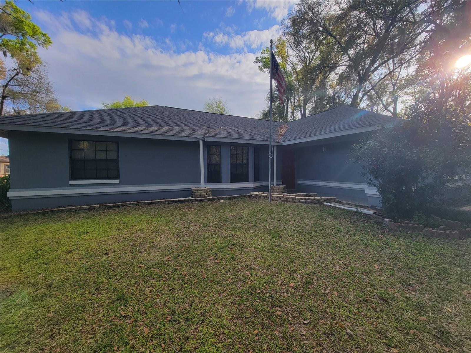 WELCOME TO YOUR FOREVER HOME!! This beautiful single-story home with 3 bedrooms, 2 baths located at the cul-de-sac with a private gate entrance. The kitchen overlooks the dining and living room. There is a separate seating area from the dining room where the fireplace is located. The sliding glass doors open to the screened porch in the rear of the property. The property has an attached 2-car garage and another 2-car detached garage at the end of a beautiful 100 ft driveway. The property has many mature trees creating lots of shade. The property is fenced in with a 4' chain link fence as well as a wood fence on the front of the property. There are several different types of roses that bloom in different colors located on the front of the property. There are two large sheds on the property as well as 4 enclosed chicken coops. The house is also fenced in with 3 entrances to the property. There is a large workshop with a large attached compressor. The workshop has high ceilings, making parking for all the additional toys. There is a large fire-pit behind the workshop as well.